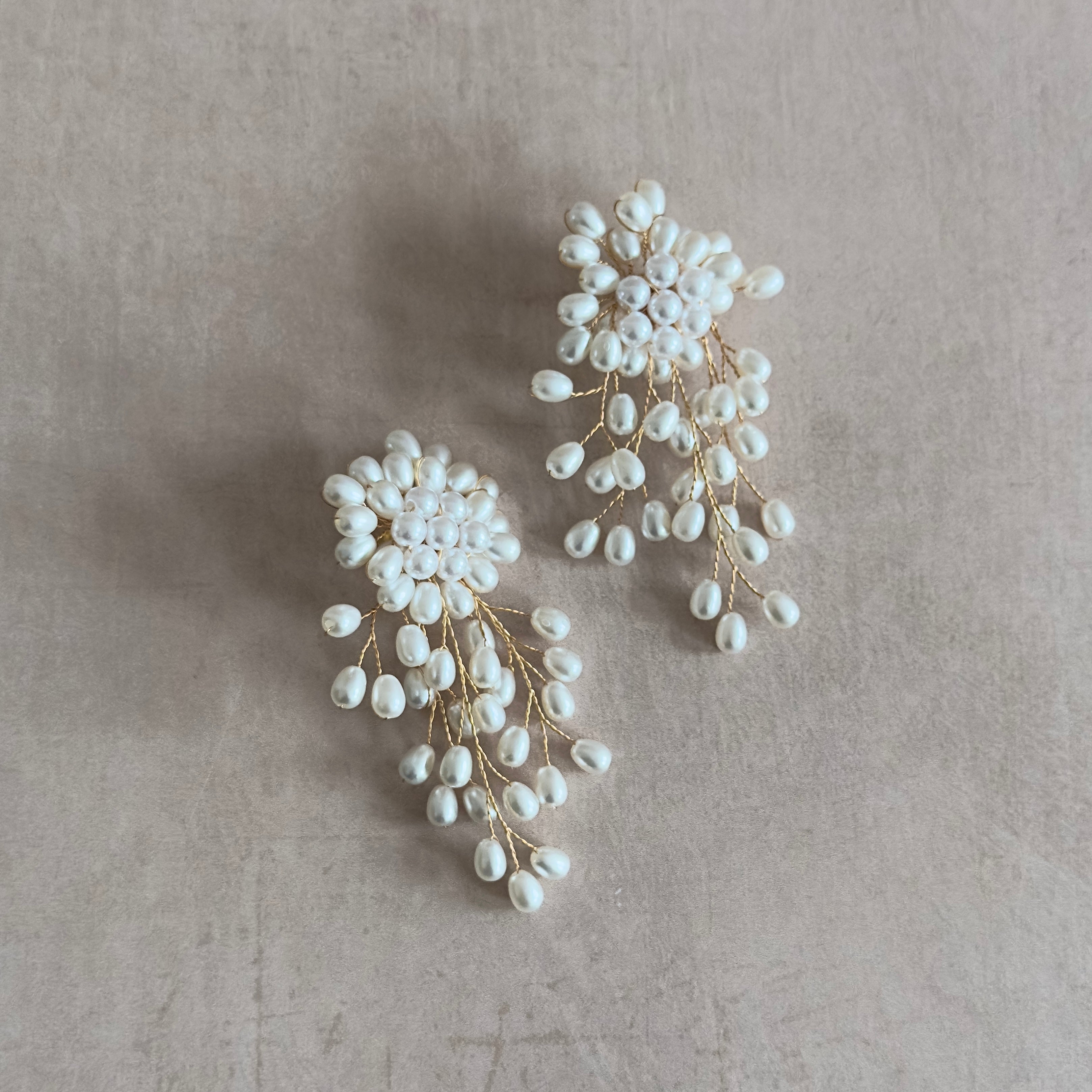 Elevate your look with these Nadia Pearl Earrings. These statement earrings will add a touch of elegance to any outfit, making you feel confident and sophisticated. A must-have for any fashion-forward individual, these earrings are the perfect accessory for any occasion.