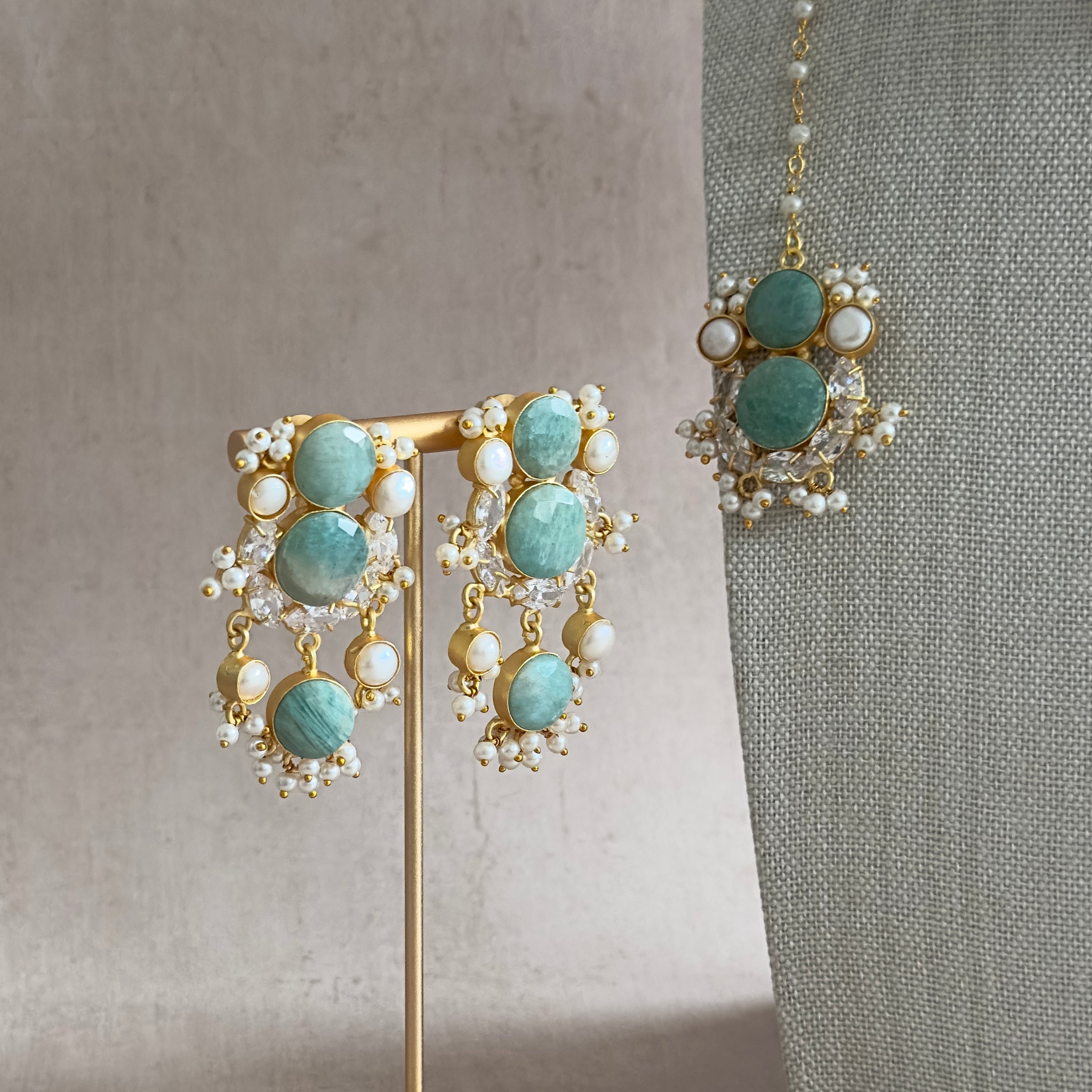 Make a statement with our Havana Jade Choker Set featuring natural amazonite stone, sparkling cubic zirconia, and unique freshwater pearls. Complete with matching earrings and tikka, this set exudes elegance and adds a touch of nature to your look. Elevate any outfit with this one-of-a-kind set!