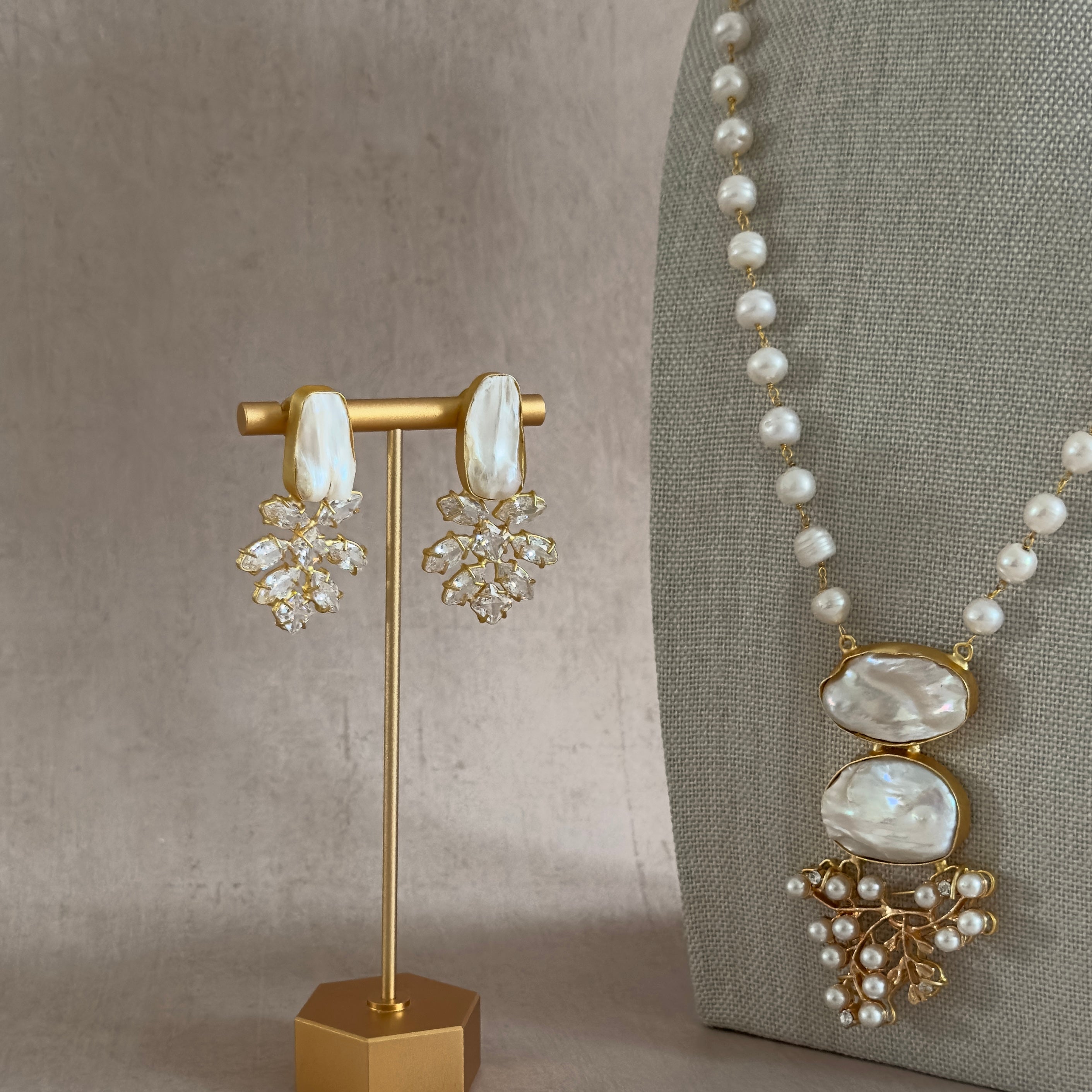 Indulge in the timeless elegance of our Baroque Pearl Mala Set. The long pearl necklace features lustrous baroque pearls, each with its own unique texture and shape, adding a touch of luxury to any ensemble. Complete the look with the matching crystal earrings for a sophisticated and exclusive finish.