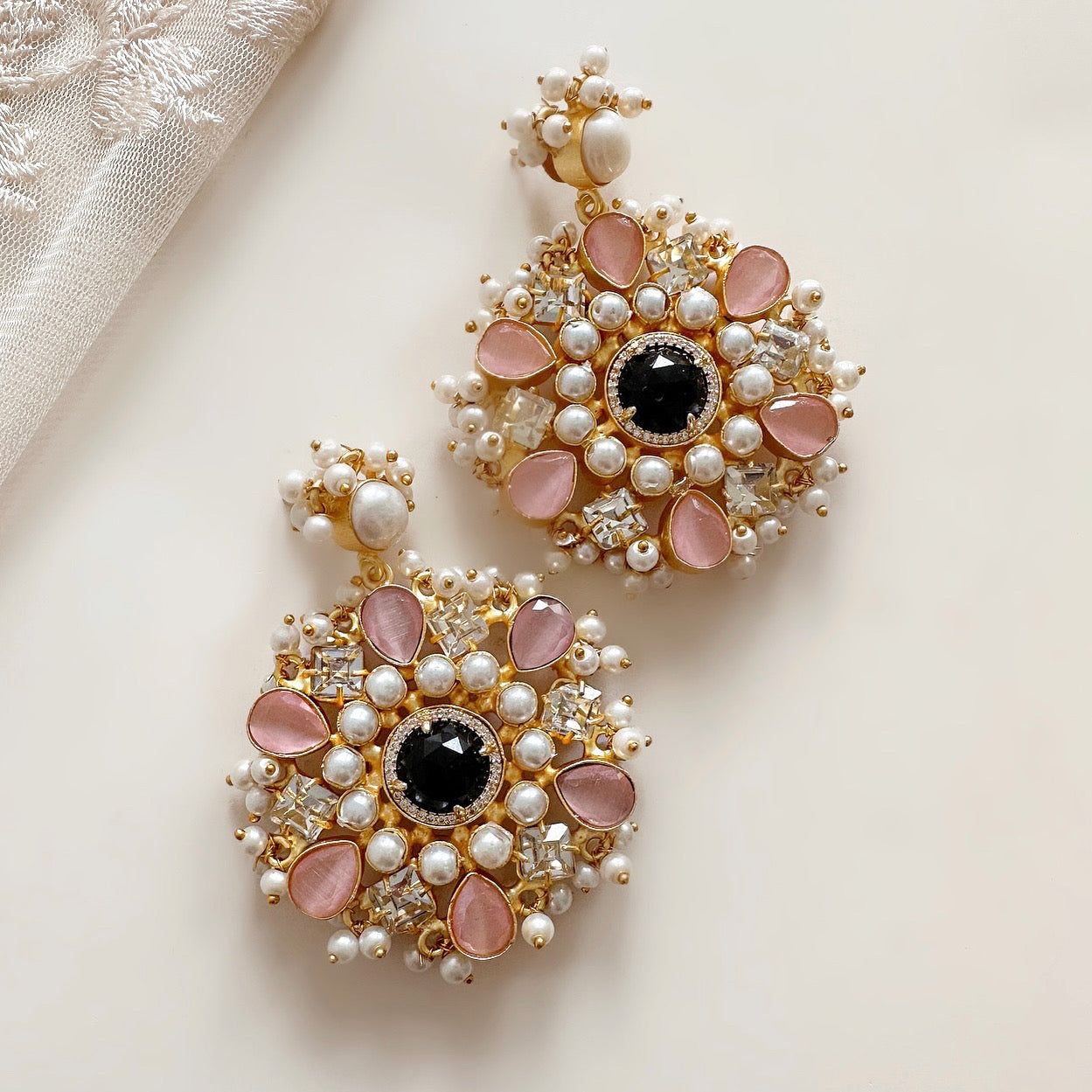 Glamourous and statement-making, the Lou Earrings add a touch of sophistication to any outfit. Featuring hues of soft pink and black, these earrings are embellished with cz crystals for extra sparkle. Elevate your look with these stunning earrings.