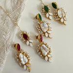 Introducing the Farah Pearl Tikka & Earring Set, crafted with luxurious baroque pearls and set with vibrant red and green corundum. An elegant statement and classic accessory for the modern woman, this set is perfect for elevating any look. Earring drop 7cm Tikka one size pearl shape may vary