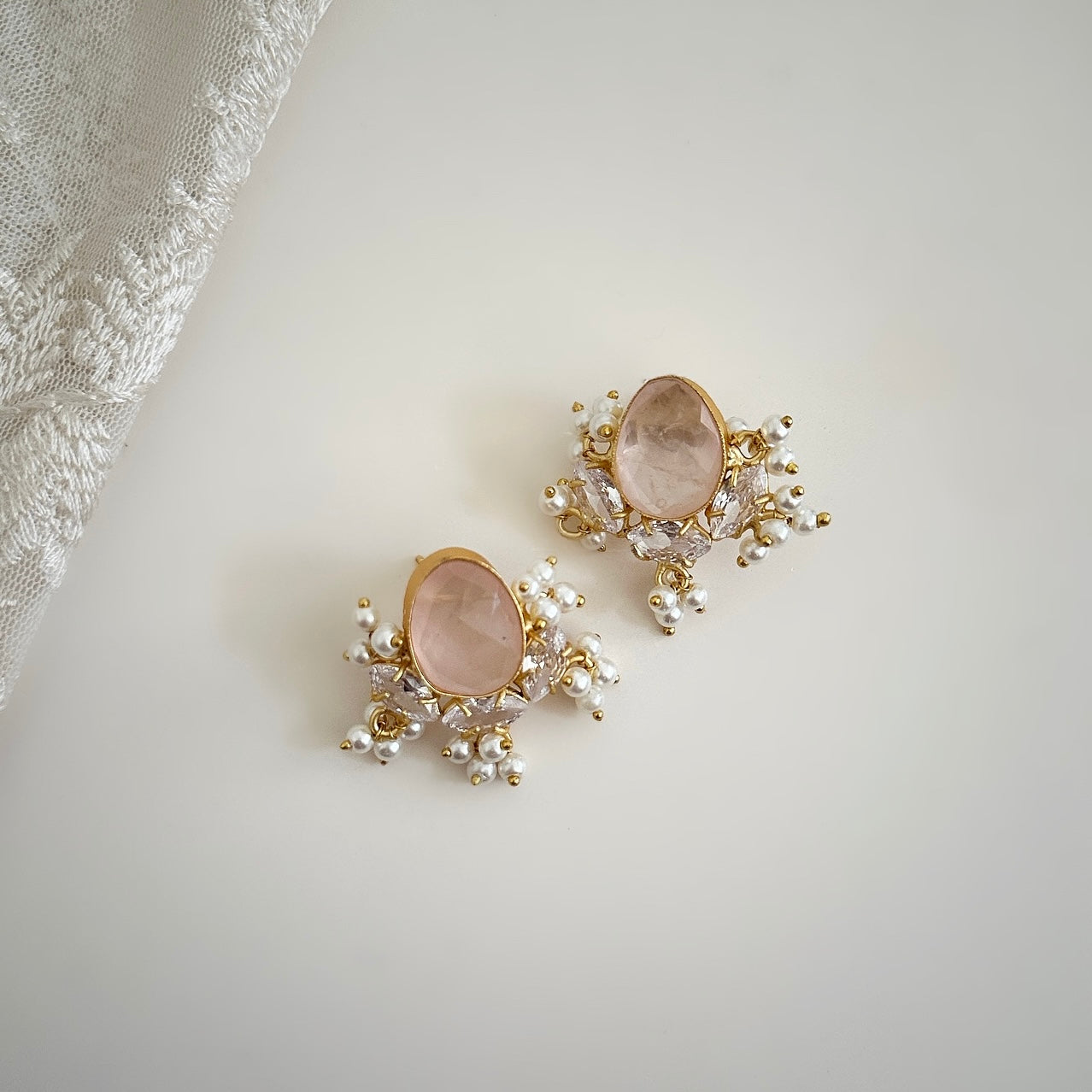 Add a touch of sparkle and elegance with our Classic Rose Stud Earrings. Made with rose quartz and cz crystals, these earrings are sure to shine and make a statement. Perfect for any occasion, these earrings will add a touch of glamour to any outfit. Earring drop 3x3cm