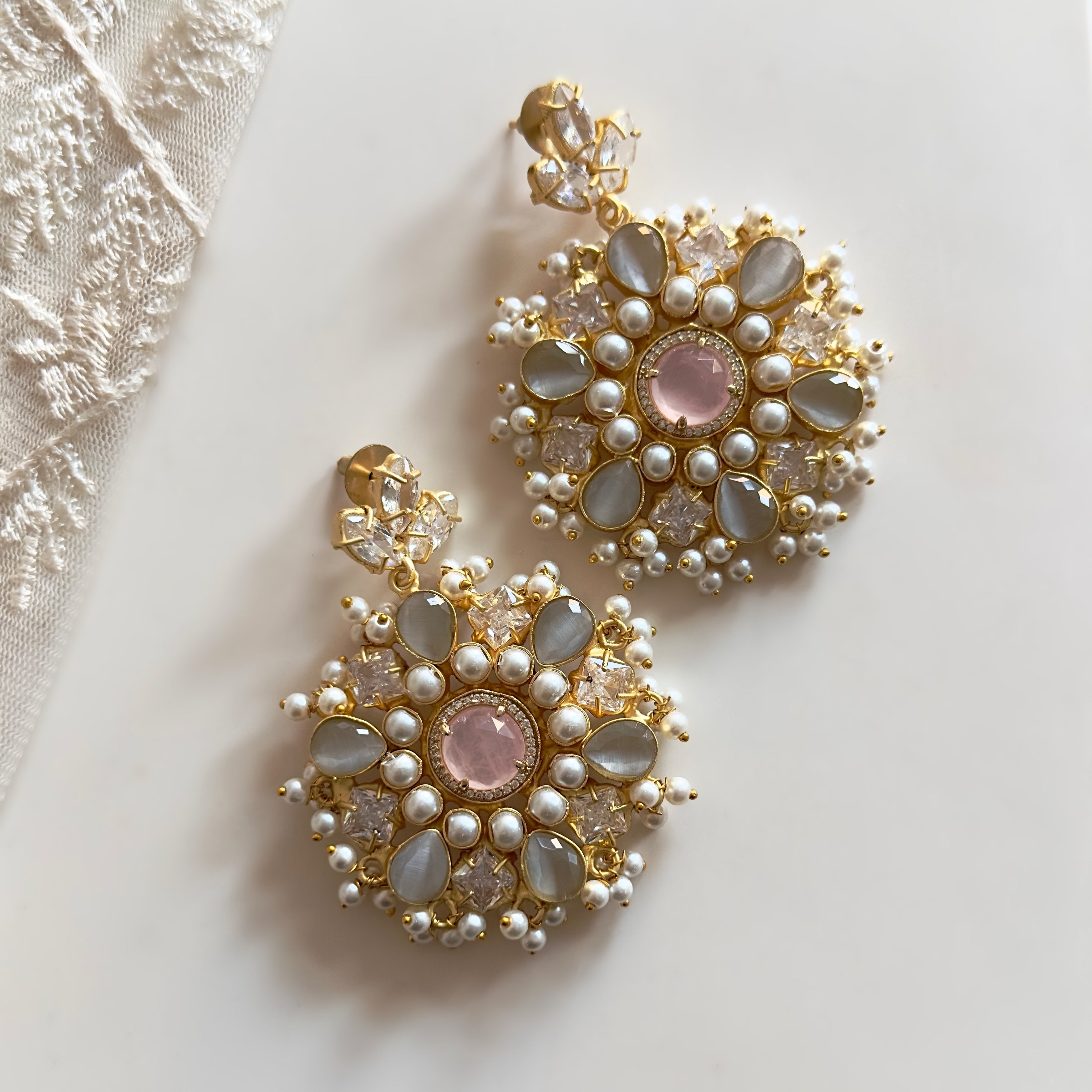 Elevate your look with our Lou Crystal Drop Earrings. The stunning hues of pink and grey, accented by luxurious cz crystals, will add an elegant touch to any outfit. With its stunning statement design, these earrings are the perfect accessory for any occasion. Make a sophisticated statement with Lou.