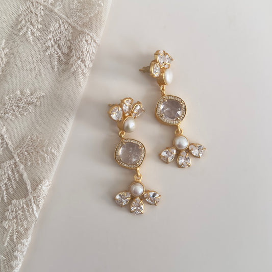 Add a touch of elegance to any outfit with our Rifa White Crystal Drop Earrings. Featuring crystal quartz and cz crystals, these earrings will add a touch of sparkle to your look. The pearl accent provides a classic and sophisticated touch, making these earrings perfect for any occasion.<br>Earring drop 6cm