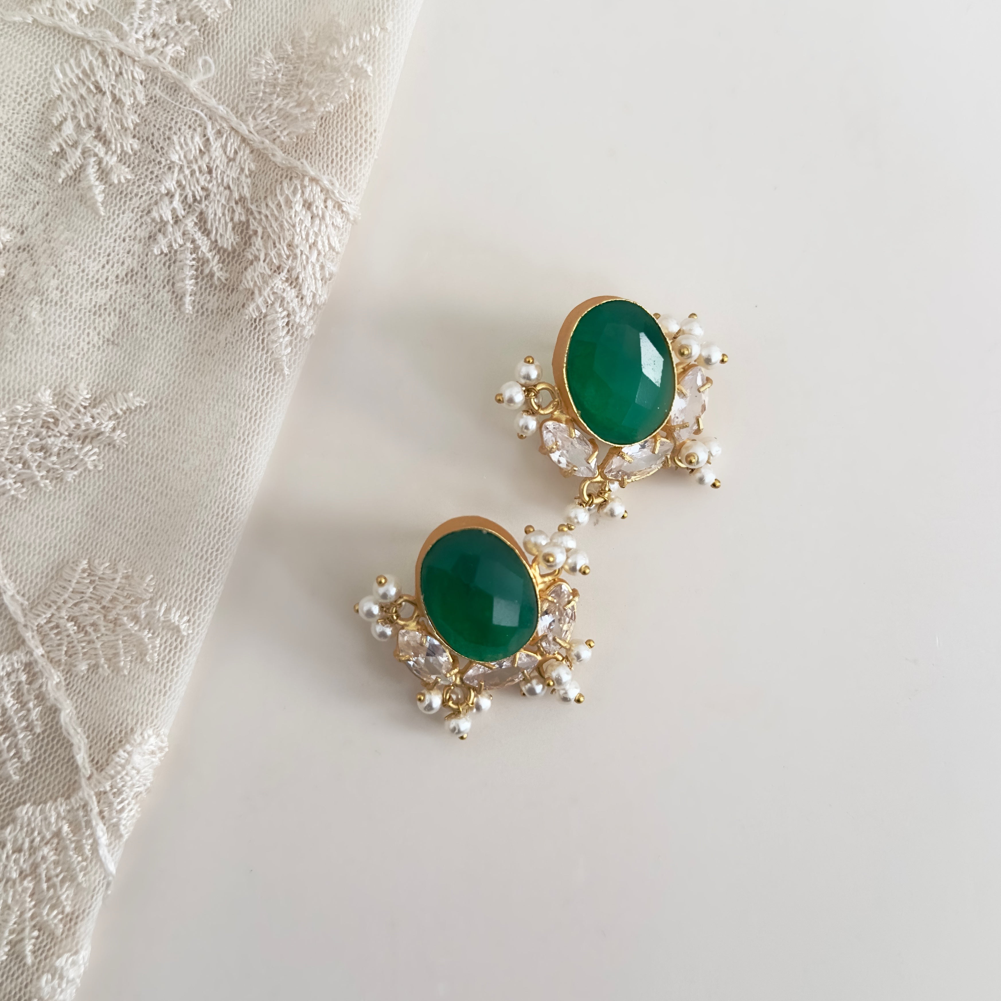 Add a pop of color to your outfit with our Classic Green Crystal Stud Earrings. The vibrant green stones are beautifully accented with cz crystals, adding a touch of sparkle to the classic design. Elevate your look with these elegant earrings.<br>Earring drop 3cm<br>Depth of stone will vary