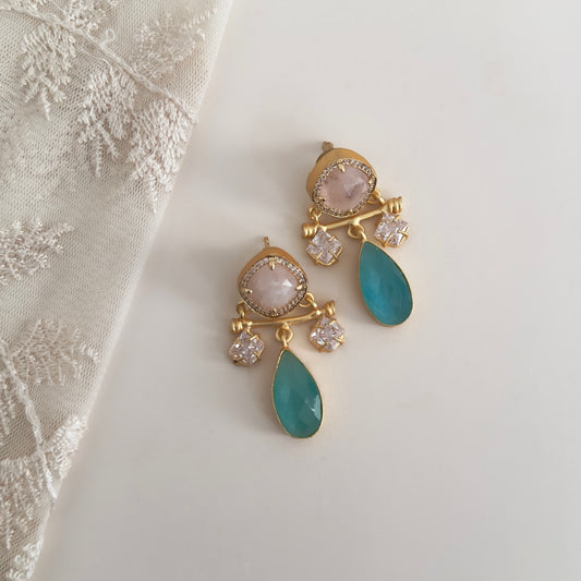 Elevate your style with these Rosy Blue Drop Earrings. The unique design features hues of aqua and blush, accented with sparkling CZ crystals. Make a statement and add a touch of elegance to any outfit.<br>Earring drop 4.5cm