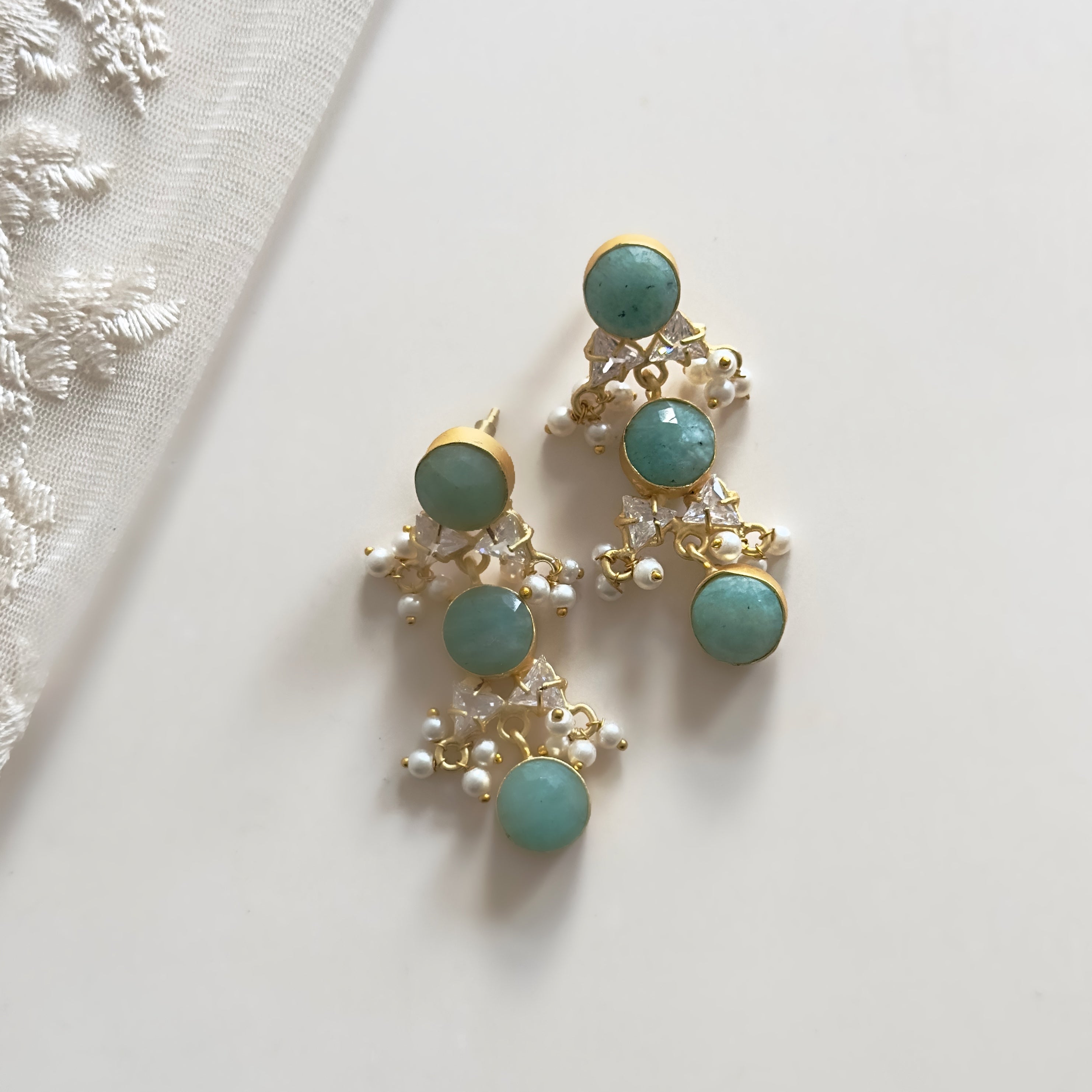 Experience beauty and elegance with our Sheena Jade Drop Earrings. These stunning earrings feature natural amazonite gemstones and sparkling cz crystals, bringing a touch of nature and luxury to your style. Elevate any outfit and feel confident and radiant wearing these exquisite earrings.