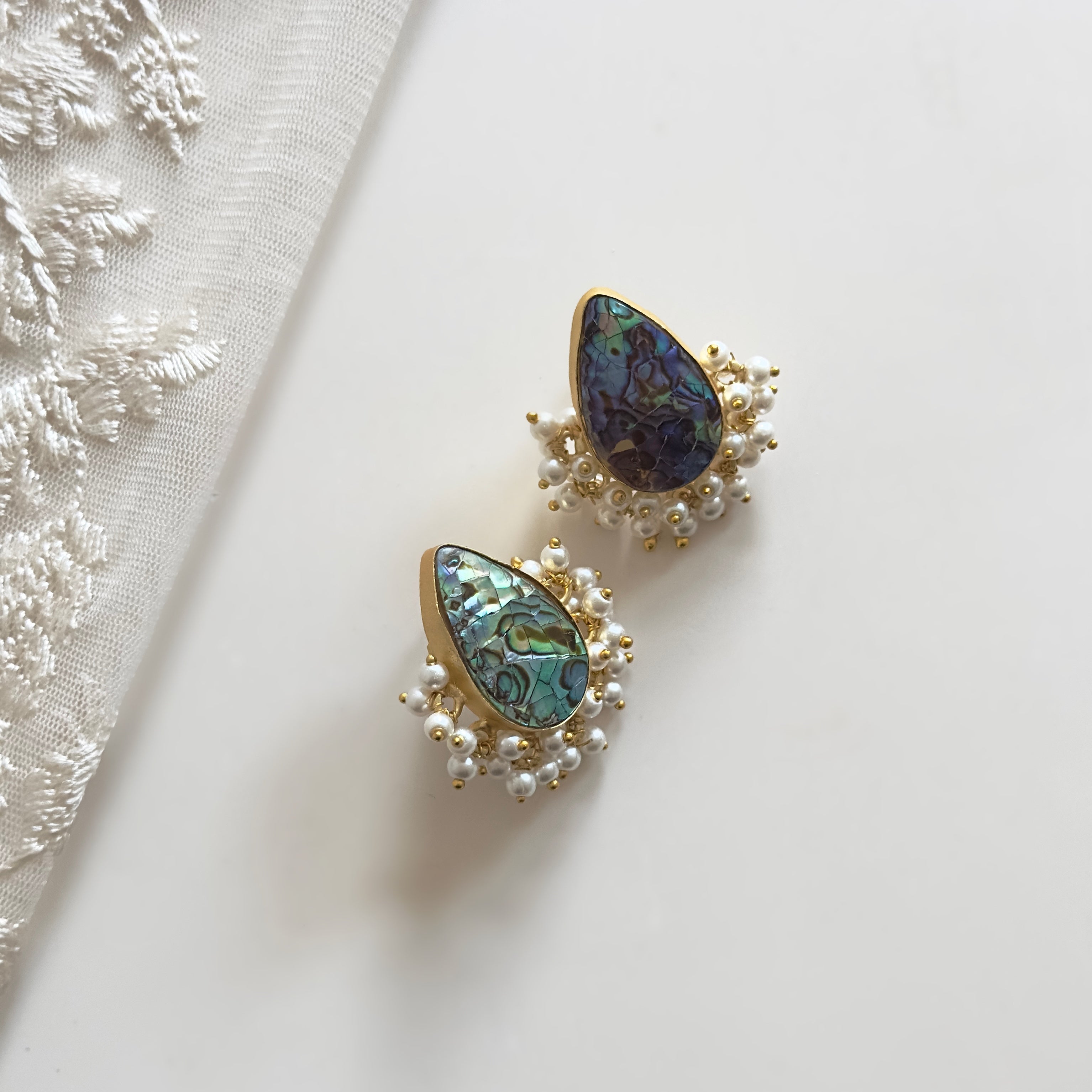 Enhance your outfit with these stunning Shell Earrings! Made from natural abalone shell, these perfect studs will add a touch of elegance and nature to your look. Handcrafted to perfection, they are a must-have accessory for any fashion-forward individual. Upgrade your style with these beautiful Shell Earrings today!