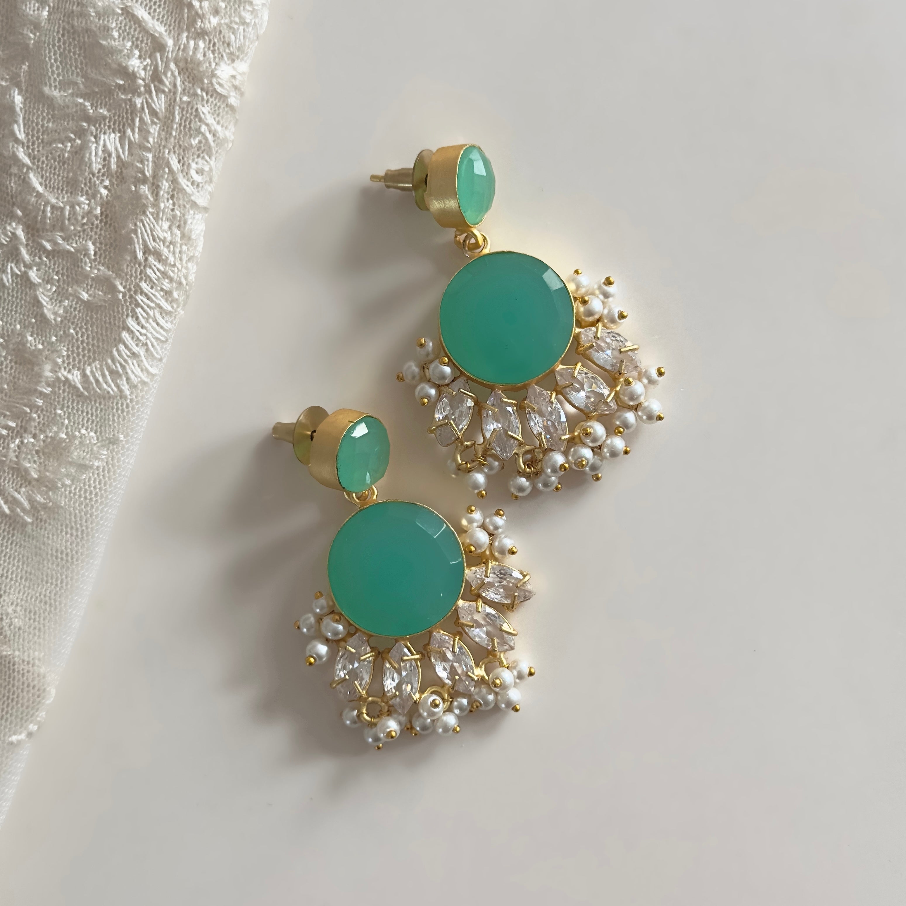 Indulge in elegance with our Marina Crystal Drop Earrings. The vibrant aquamarine and stunning CZ crystals will add a touch of glamour to any outfit. Elevate your style and make a statement with these mesmerizing earrings!