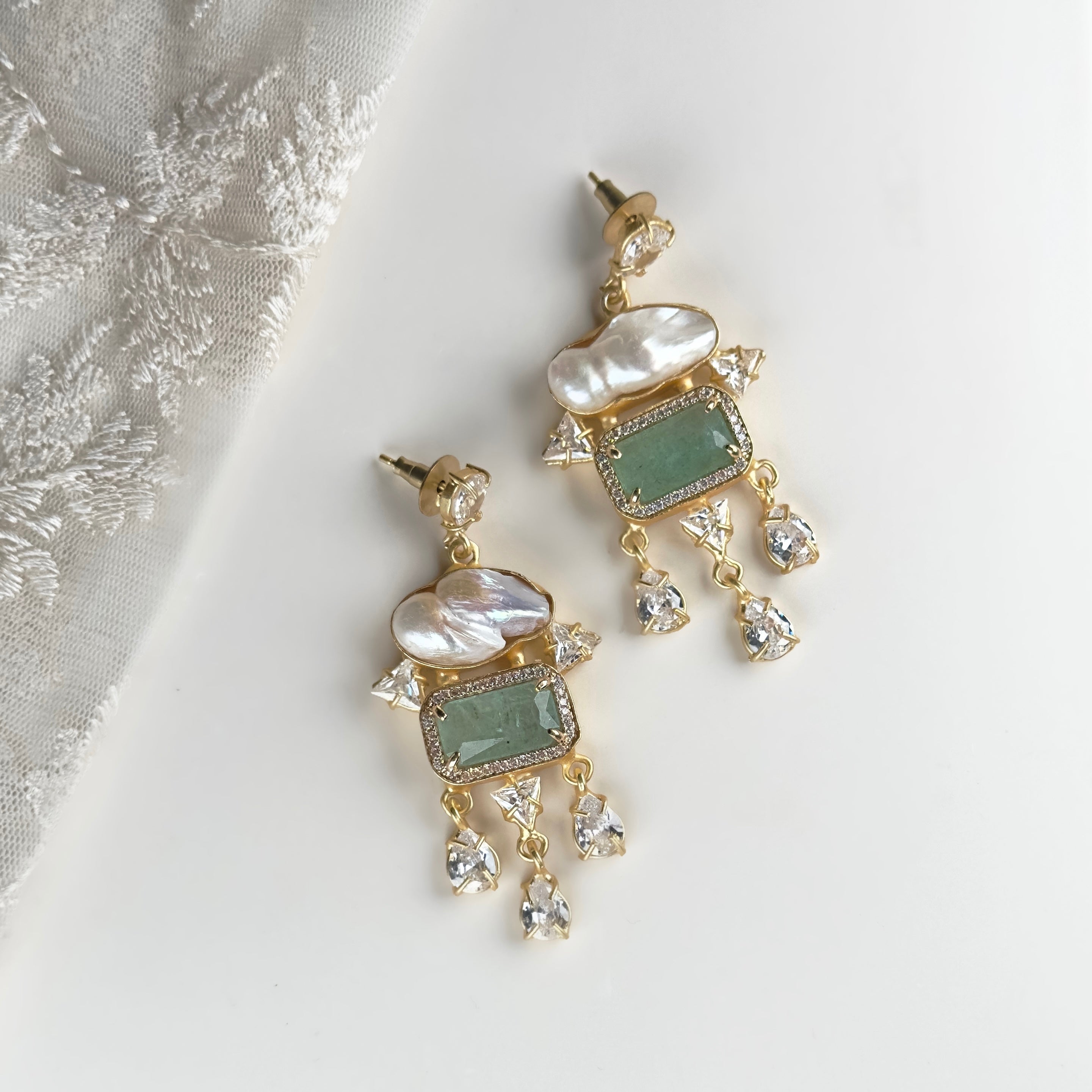 Create a simple and elegant look with our Safa Crystal Drop Earrings. Featuring a baroque pearl, aquamarine stone, and sparkling CZ crystals, their drop design adds a touch of sophistication to any outfit. Elevate your style with these beautiful and versatile earrings.<br>Earring drop 6.5cm