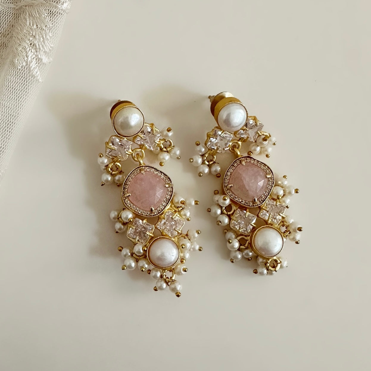 Enchanting and elegant, these Sana Earrings exude luxury. Crafted with a rose quartz centerpiece and pearl accents, they feature dazzling CZ crystals that will sparkle in any light. An ideal accessory for special occasions, this timeless design is sure to add a hint of sophistication to any ensemble. Earring drop: 6cm