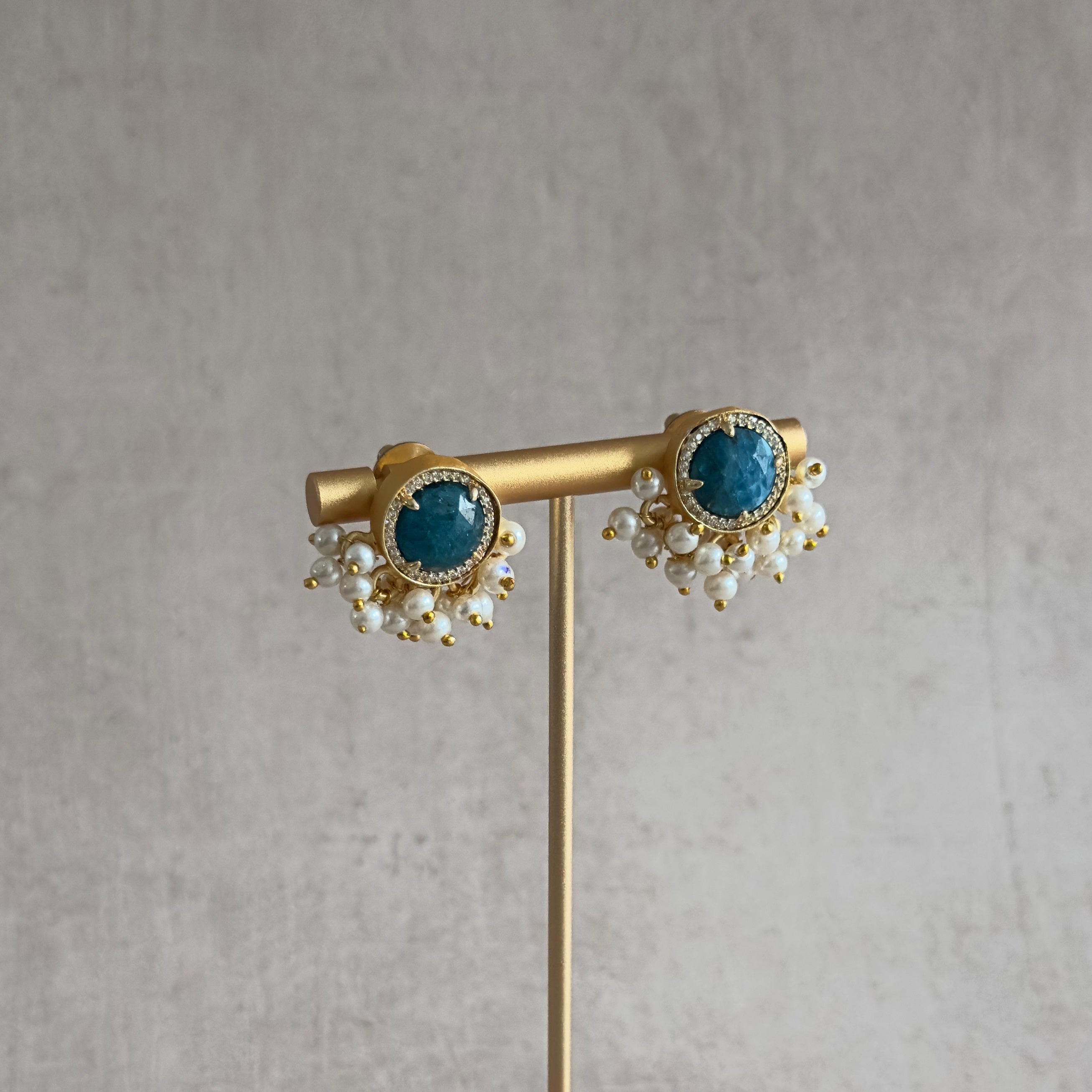 Elevate your style with our Indi Teal Stud Earrings. These earrings feature a classic stud design that adds timeless elegance to any outfit. Make a statement with confidence and sophistication.