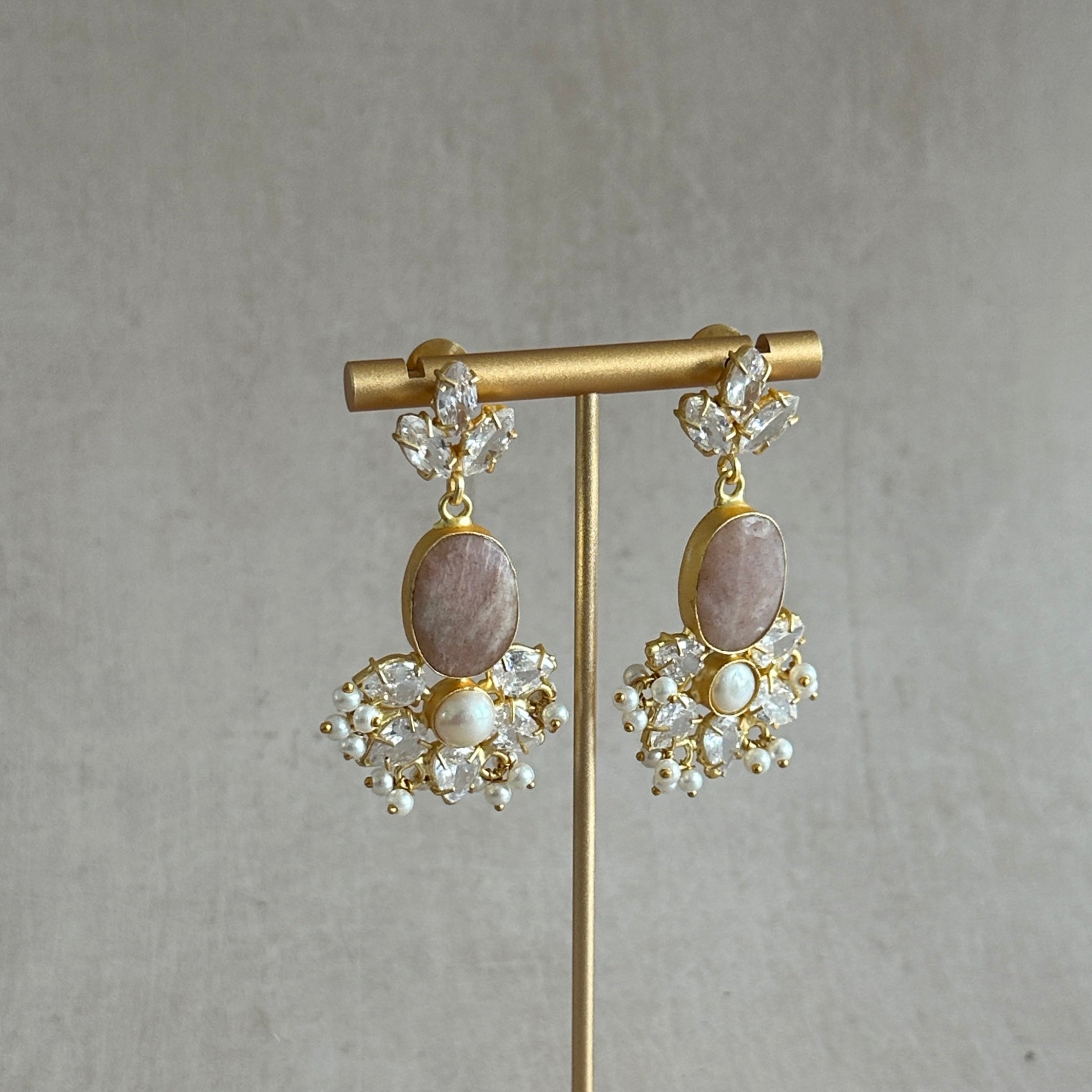 Add a touch of elegance to any outfit with the Alara Mink Crystal Drop Earrings. These exquisite earrings feature sparkling cubic zirconia and delicate pearl accents, providing a sophisticated and glamorous look for any occasion. Elevate your style with these stunning earrings.