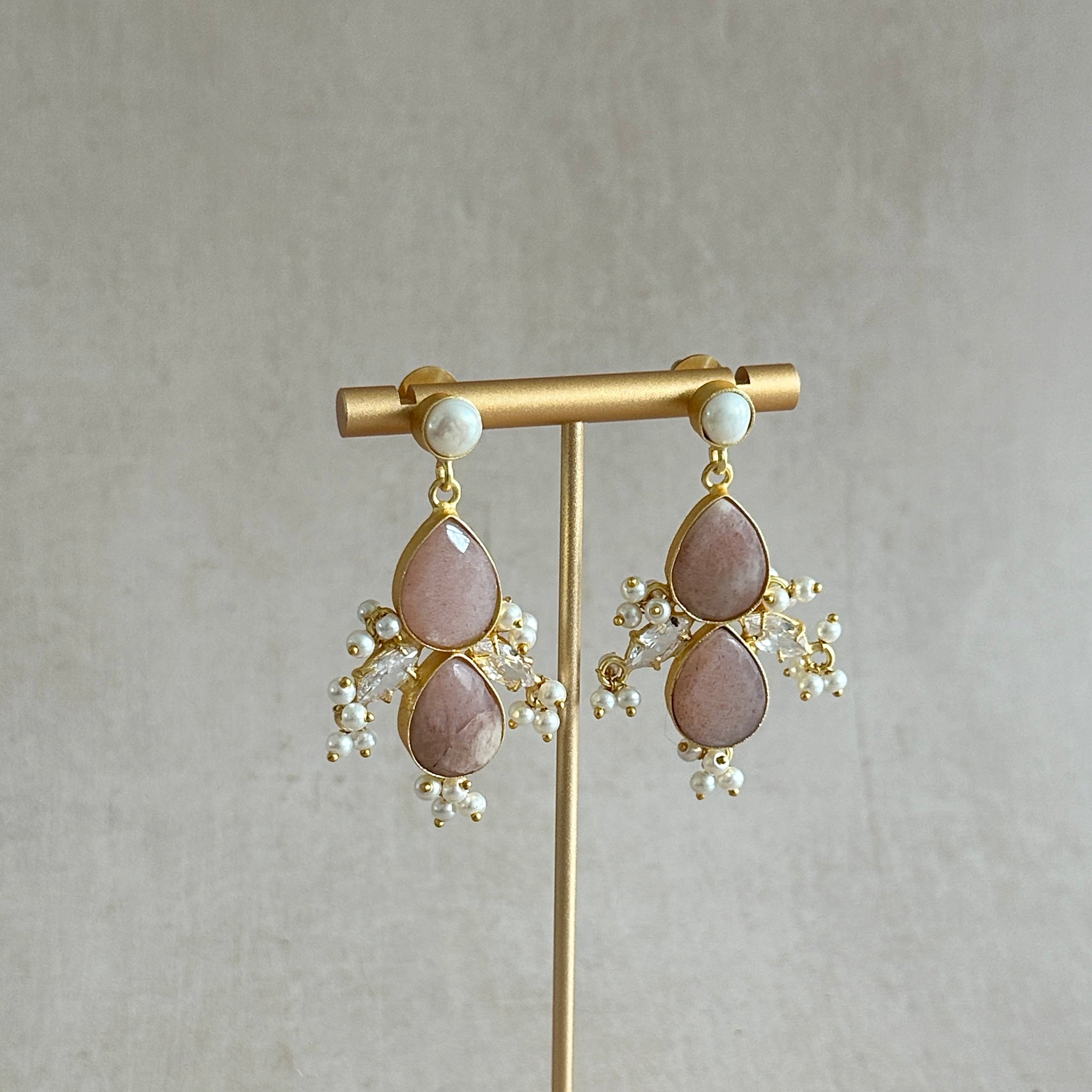 Add a touch of elegance to any outfit with our Mink Crystal Drop Earrings. These stunning earrings feature a beautiful pearl accent and sparkling cubic zirconia, creating a timeless and sophisticated drop design. Elevate your style with our must-have accessories.