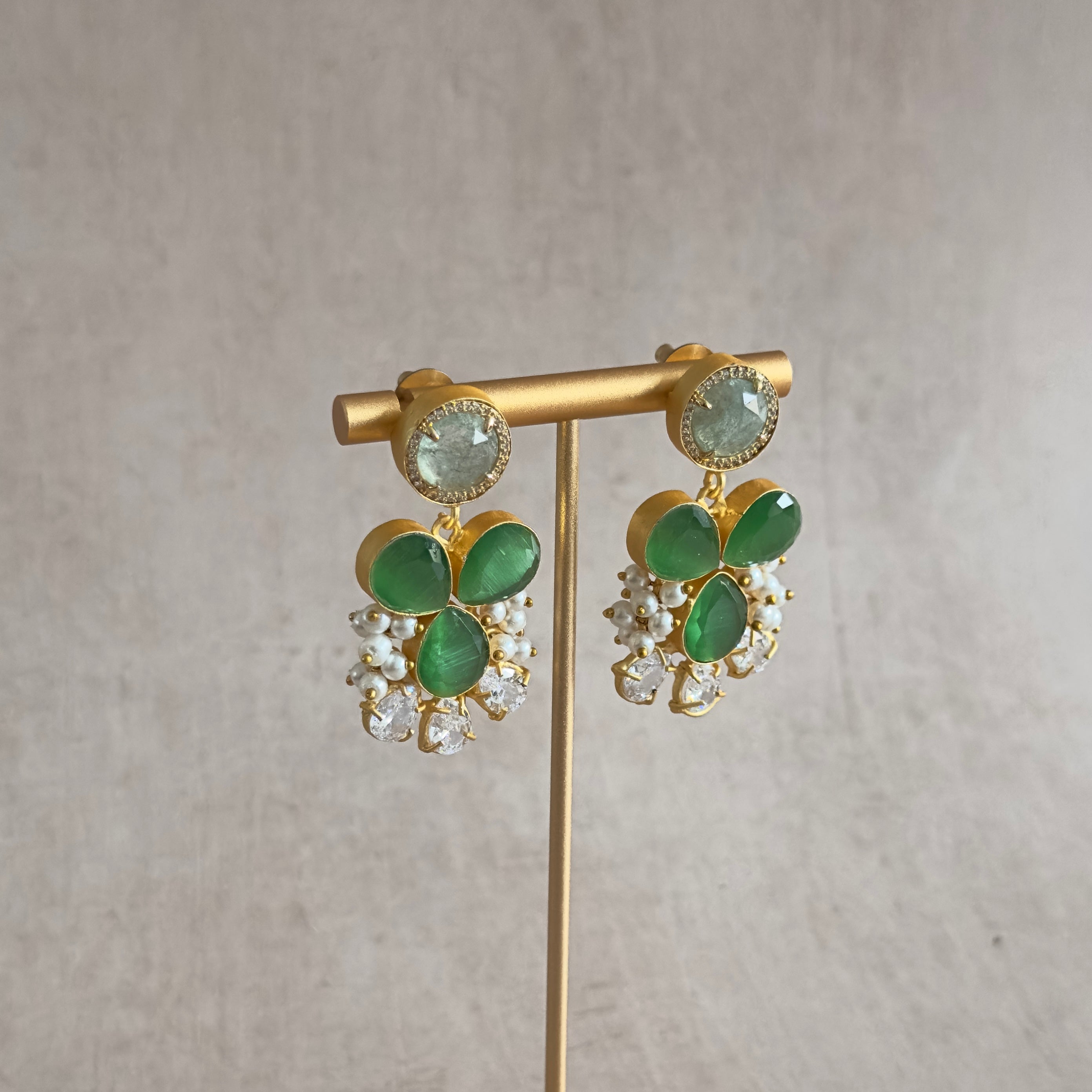 Elevate your style with the stunning Sirena Green Stud Earrings! These earrings feature mesmerizing vibrant hues of green and aquamarine, accentuated with sparkling cubic zirconia. Perfect for any occasion.
