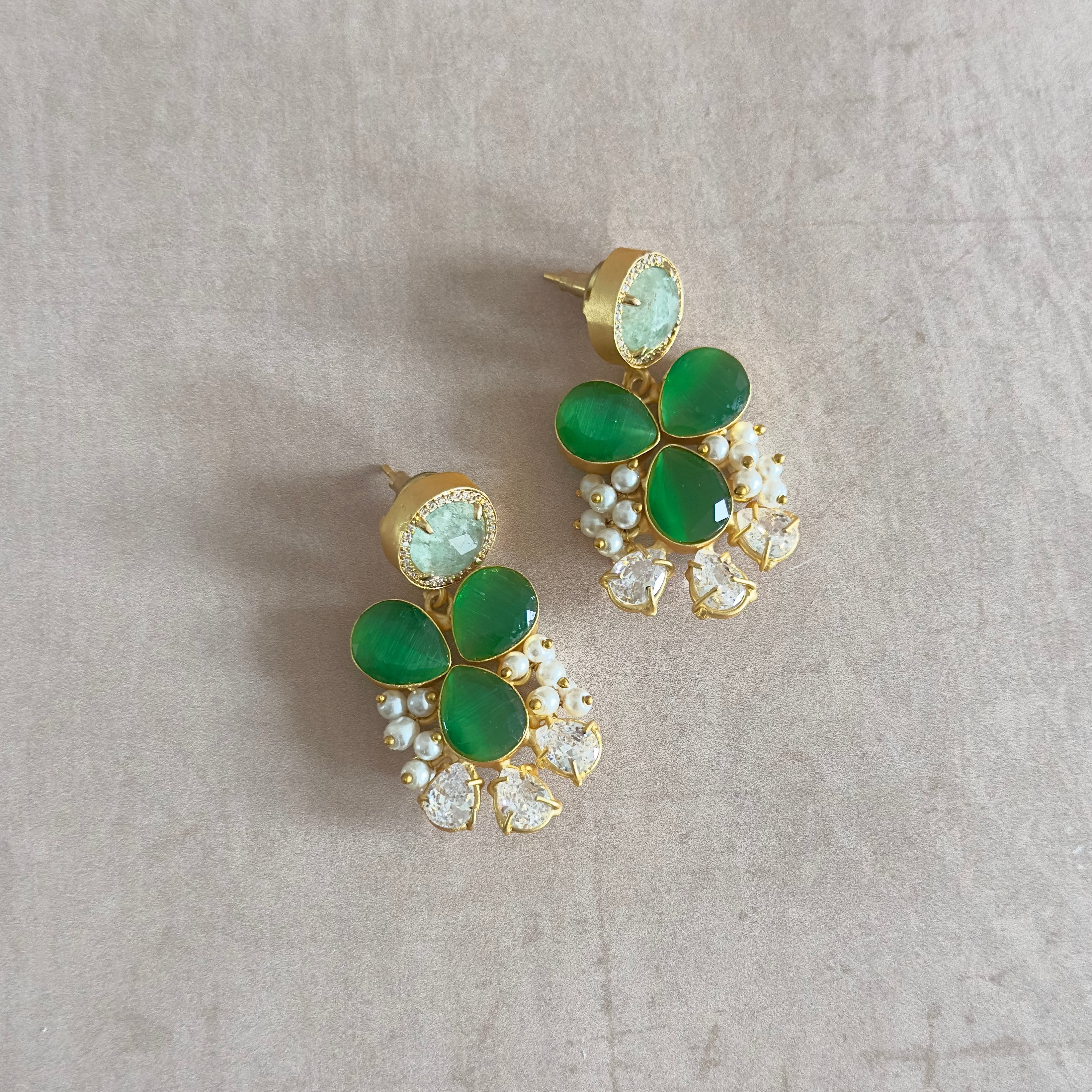 Elevate your style with the stunning Sirena Green Stud Earrings! These earrings feature mesmerizing vibrant hues of green and aquamarine, accentuated with sparkling cubic zirconia. Perfect for any occasion.