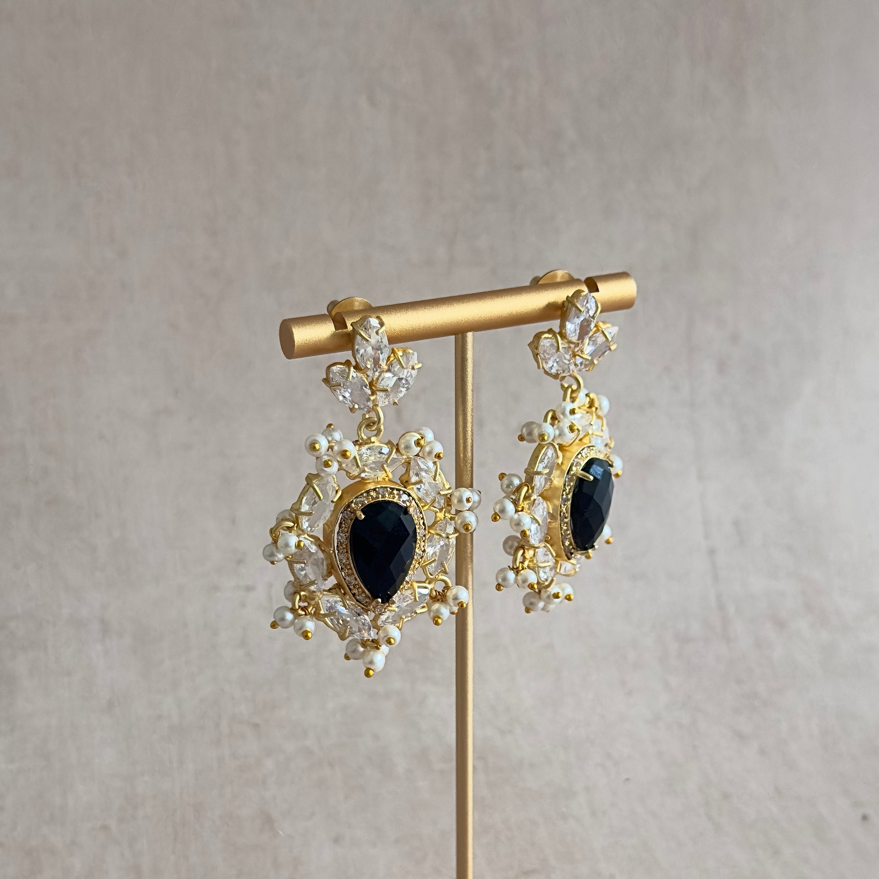 Elevate your style with our Tahira Black Crystal Drop Earrings. Crafted with stunning black onyx and sparkling cubic zirconia, these statement earrings add a touch of sophistication and glamour to any outfit. Fashion meets elegance with these must-have accessories.