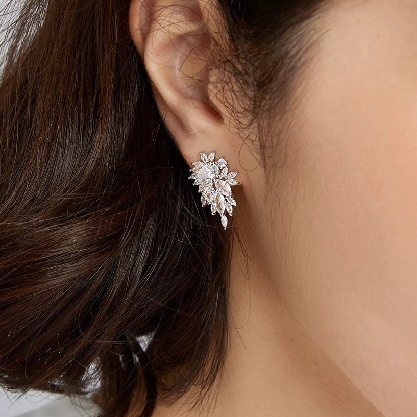 These Ilaria Crystal Earrings feature an elegant design accentuated by sparkling CZ crystals, sure to enhance any ensemble. Their unique silhouette adds a touch of sophistication to any look. Earring drop 2.3cm