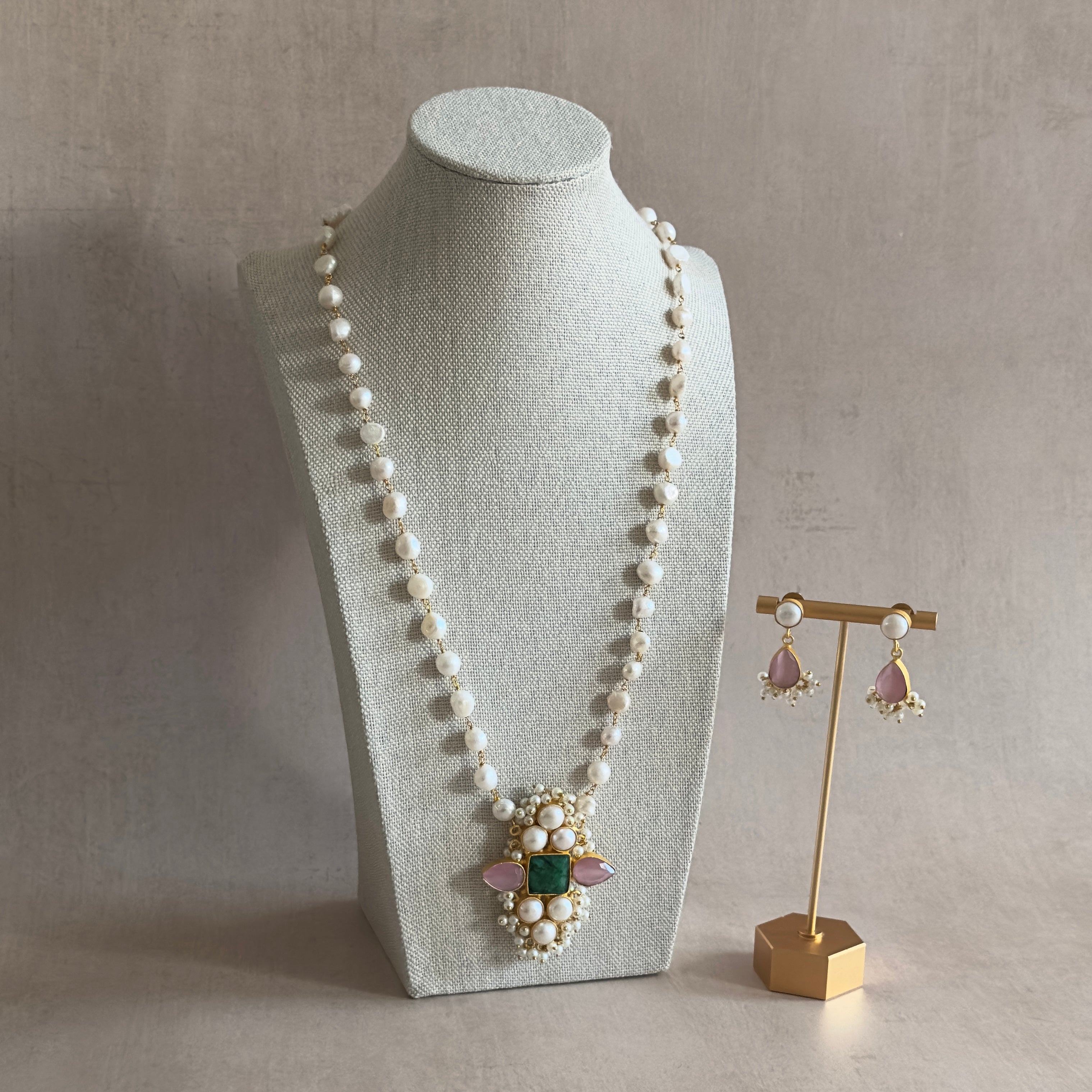 Elevate your look with our stunning Heera Pearl Mala Set. This multi gemstone mala set features gorgeous hues of pink and green, exuding a sense of beauty and charm. Complete with matching earrings for a touch of elegance. Perfect for any occasion.