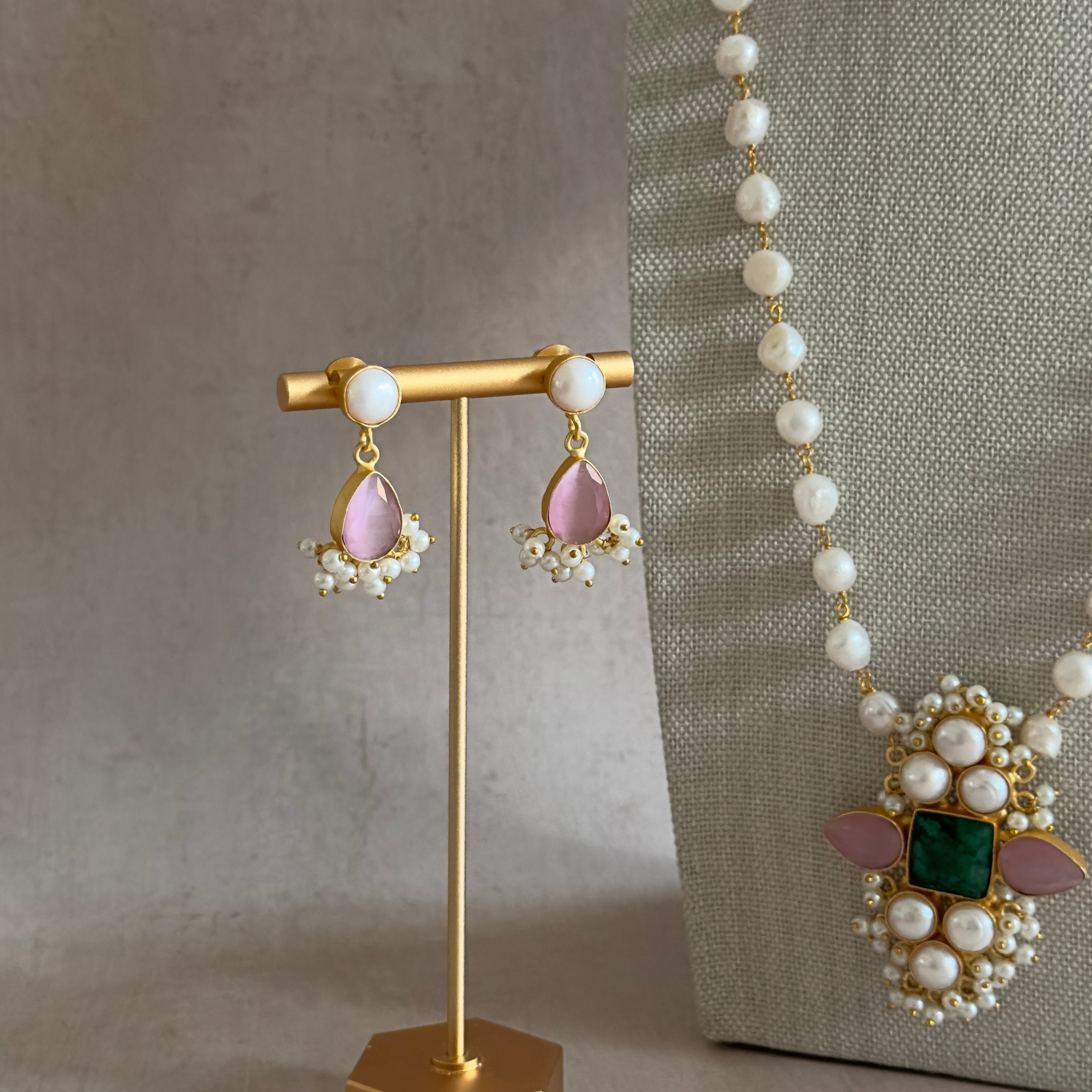 Elevate your look with our stunning Heera Pearl Mala Set. This multi gemstone mala set features gorgeous hues of pink and green, exuding a sense of beauty and charm. Complete with matching earrings for a touch of elegance. Perfect for any occasion.