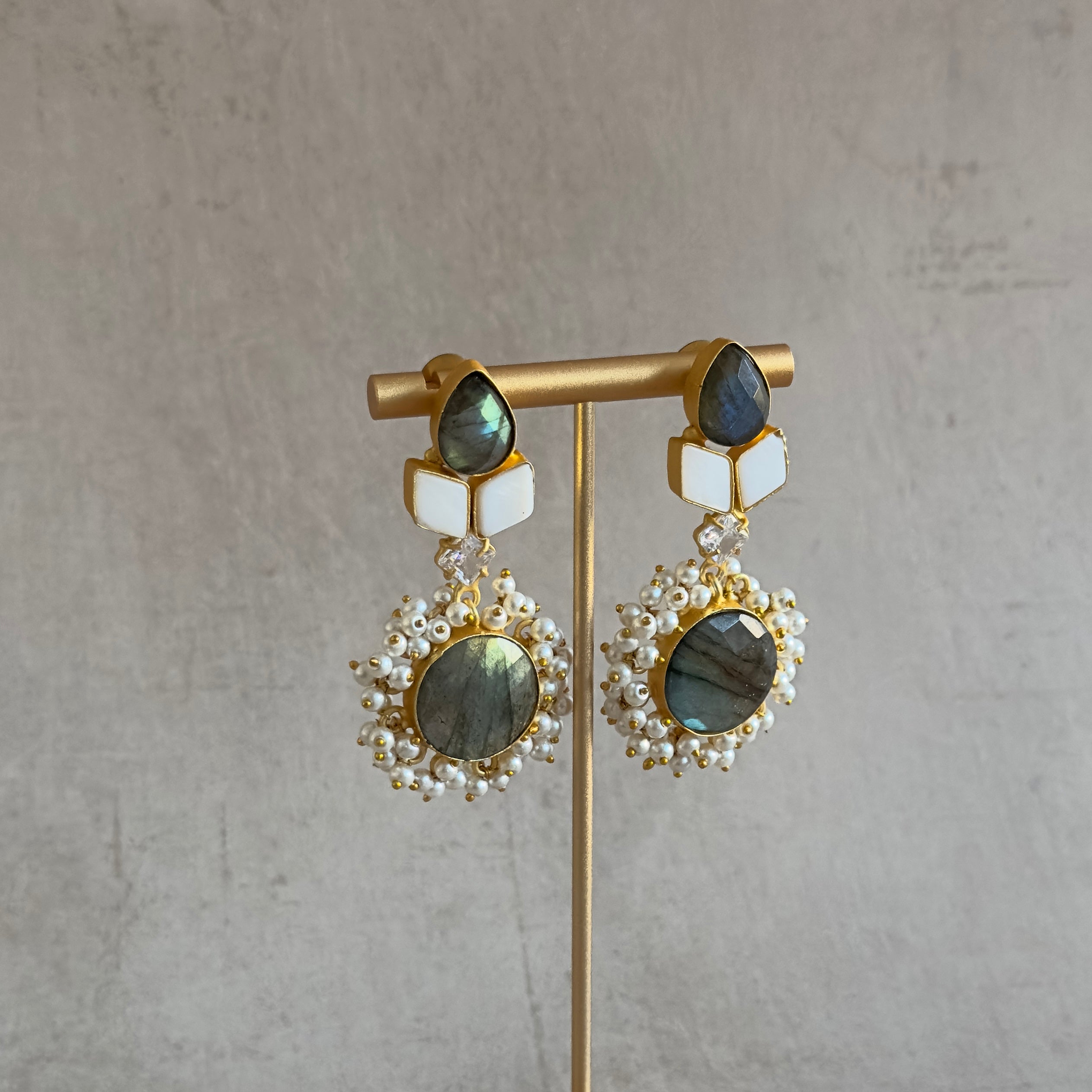 Made with stunning labradorite gemstones and mother of pearl, our Mara Drop Earrings are a must-have for any jewelry lover. These gorgeous earrings are perfect for adding a touch of elegance and sophistication to any outfit. Upgrade your accessory game with the Mara Drop Earrings!