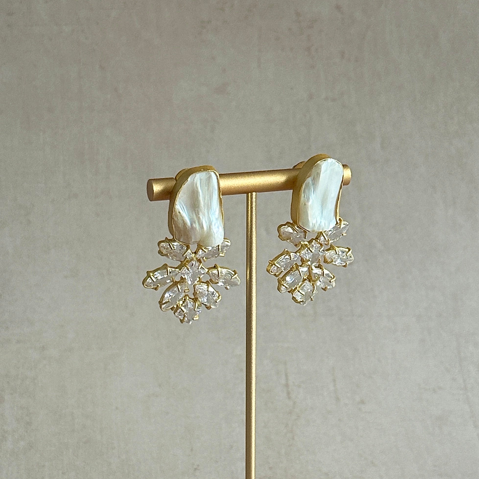 Elevate your accessory game with our Baroque Pearl Crystal Stud Earrings! These stunning studs feature naturally formed baroque pearls, each with a distinctive shape and texture. To add a touch of glamour, the CZ crystals will have you sparkling all evening. Bring a touch of elegance to any outfit with these one-of-a-kind earrings.