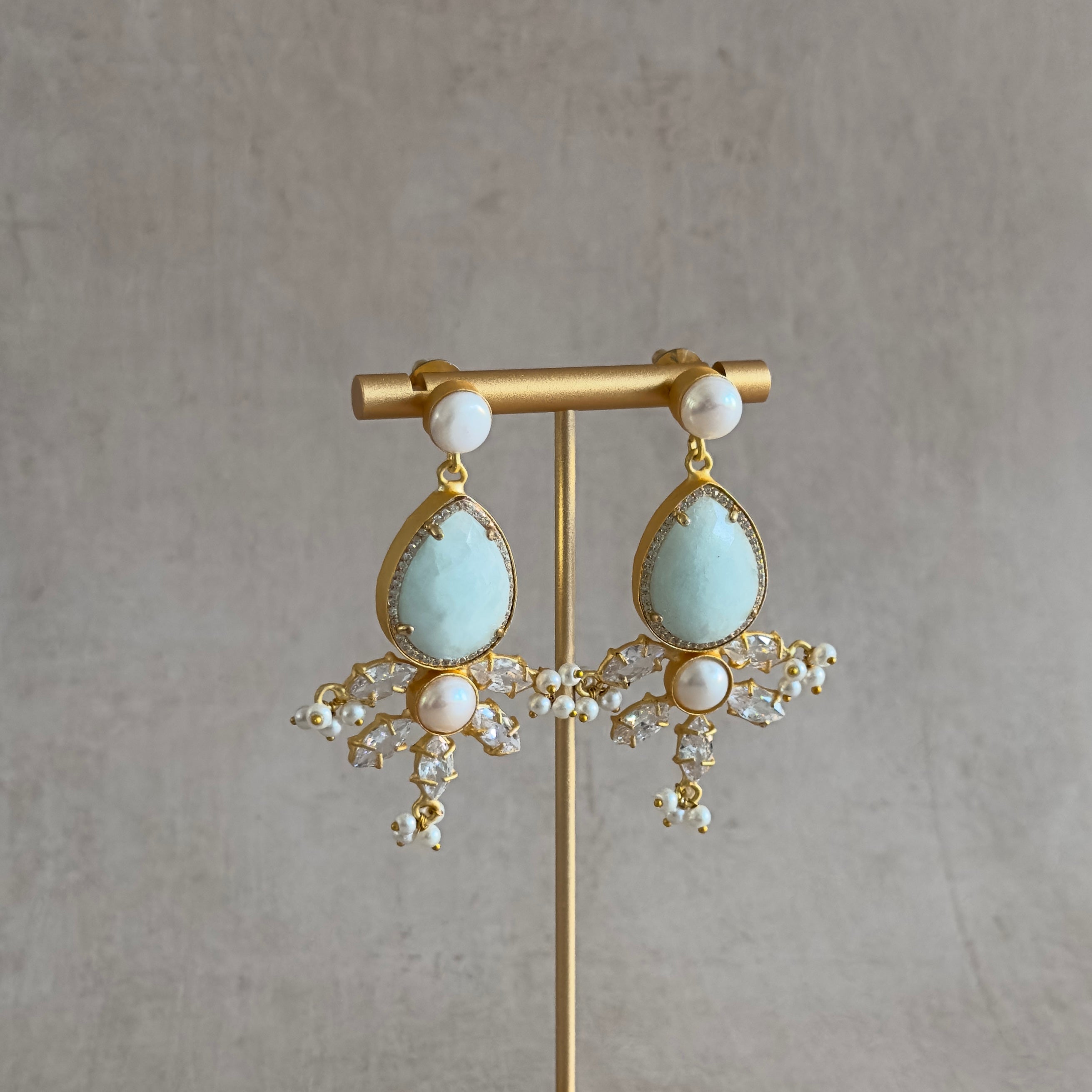 Enhance your look with the elegant hues of jade and pearl in these Simone Crystal Drop Earrings. Featuring luscious CZ crystals, these earrings will add a touch of sophistication and glamour to any outfit. Elevate your style and make a statement with these stunning earrings.