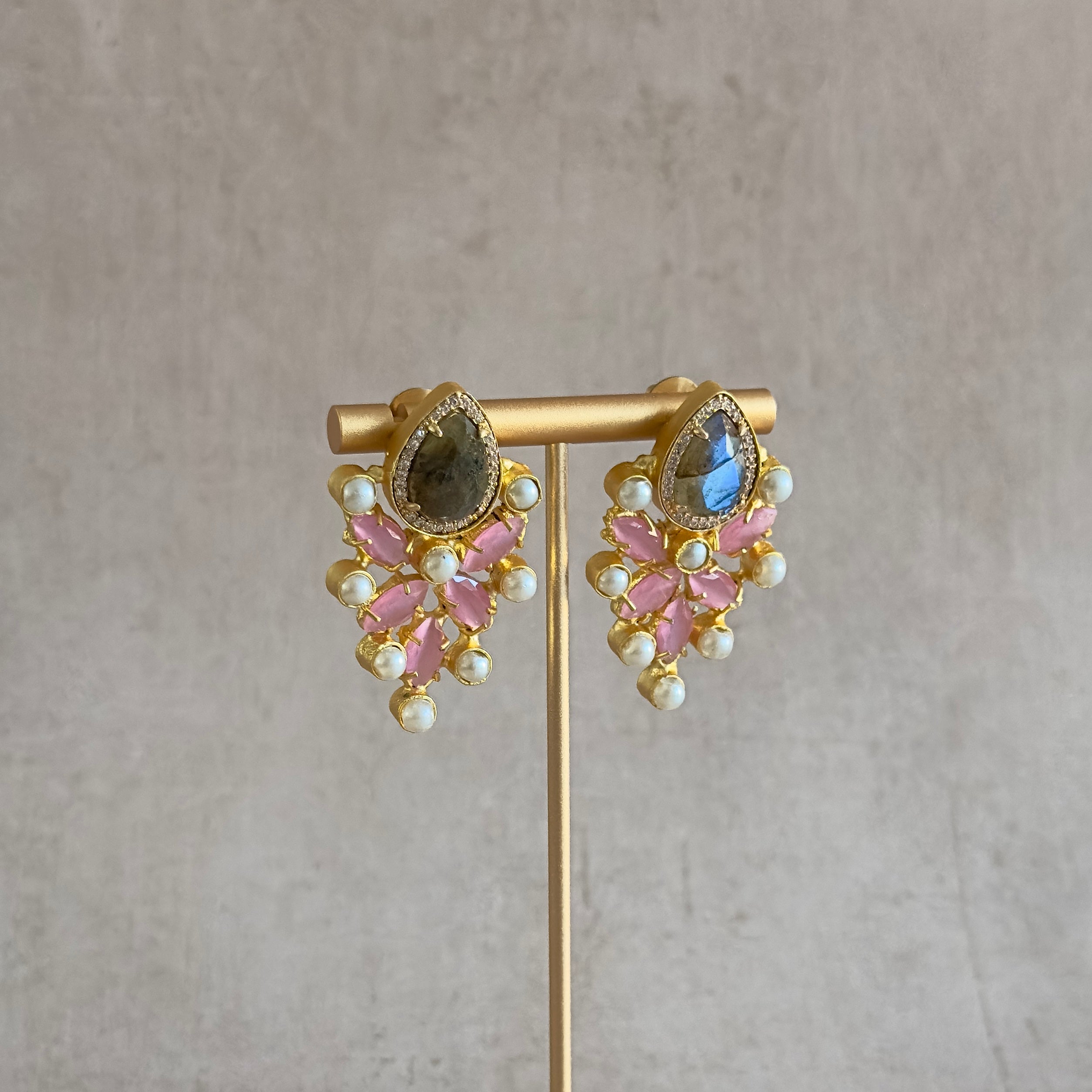 Make a stylish statement with these stunning Pink Earrings. The labradorite stones are surrounded by pink semi-precious gems, making them a truly luxurious piece of jewelry that will create a lasting impression. Adorned with timeless beauty, these earrings are the perfect addition to any special occasion.
