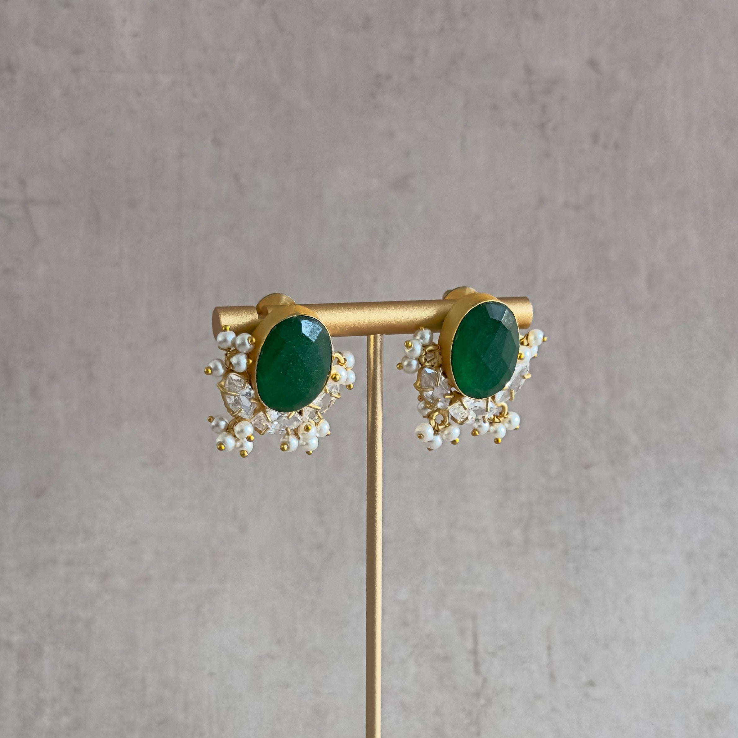 Add a pop of color to your outfit with our Classic Green Crystal Stud Earrings. The vibrant green stones are beautifully accented with cz crystals, adding a touch of sparkle to the classic design. Elevate your look with these elegant earrings.