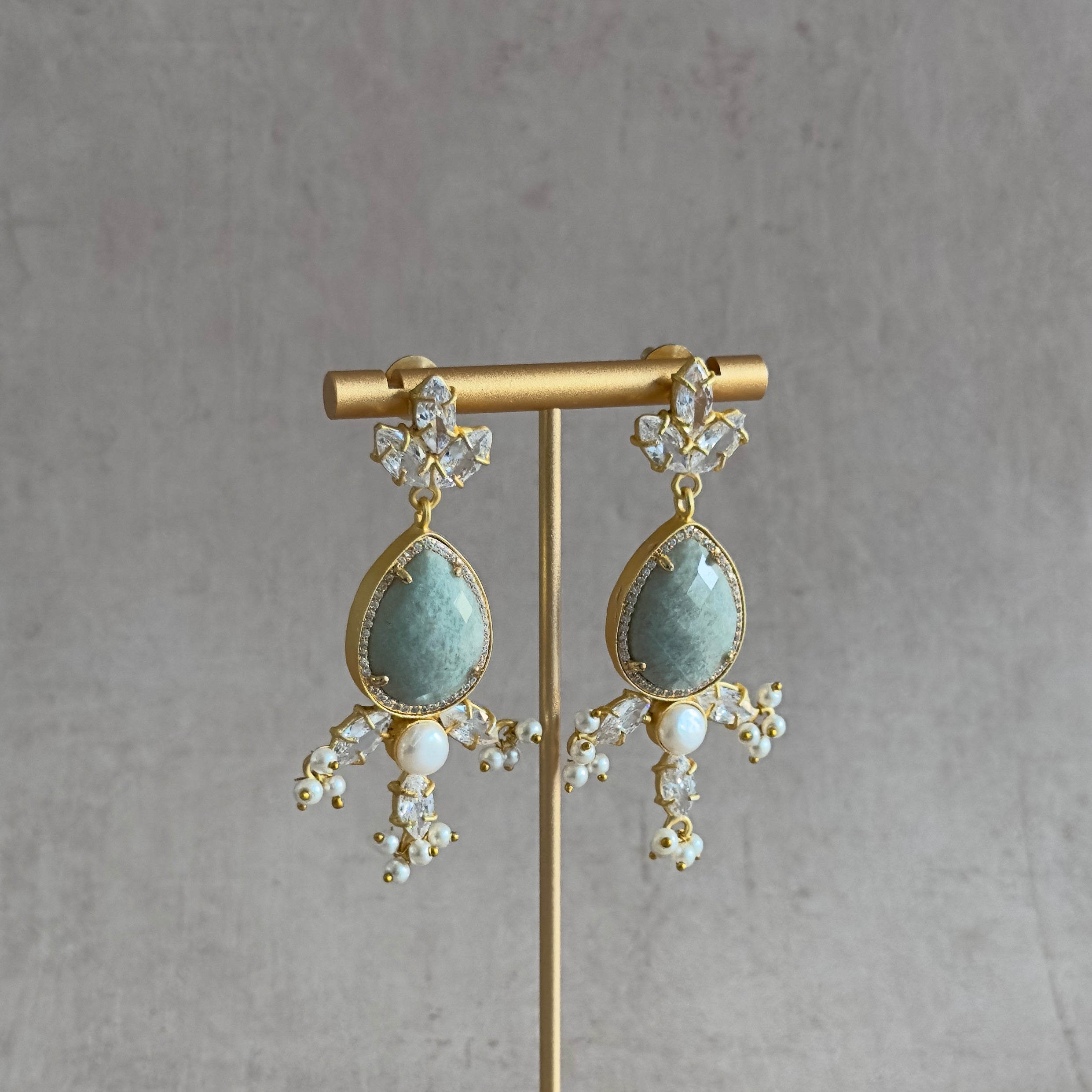Add elegance to your look with the Simone Jade Crystal Drop Earrings. Crafted with amazonite stones, cz crystals, and pearl accents, these earrings will bring sophistication and beauty to any occasion. Ready to make a bold statement? Elevate your style with the Simone.