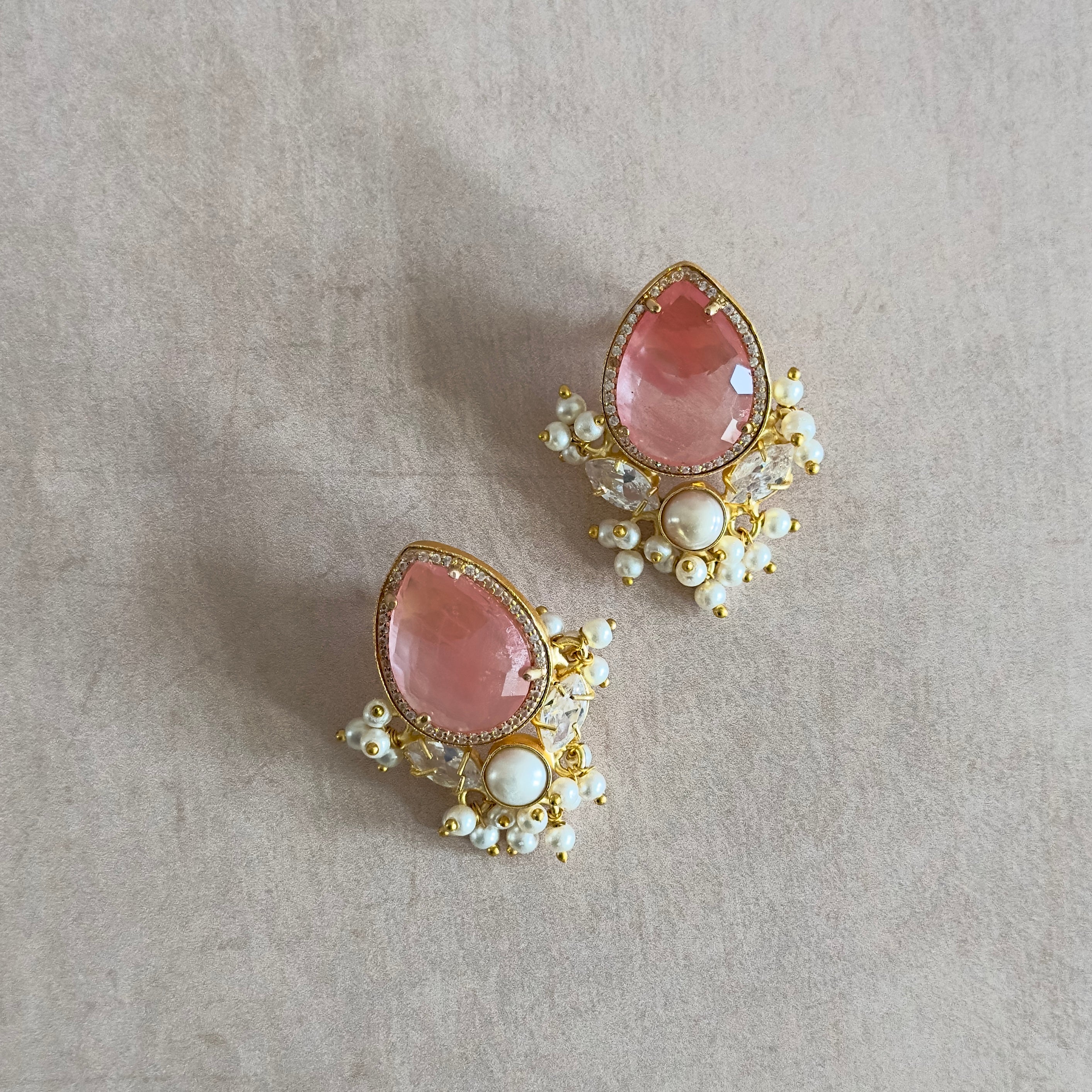 Add a touch of elegance with our new Bria Earrings featuring a crimson quartz center stone, pearl accents, and sparkling cz crystals. Elevate any outfit with a pop of color and shine. A must-have for the fashion-forward.