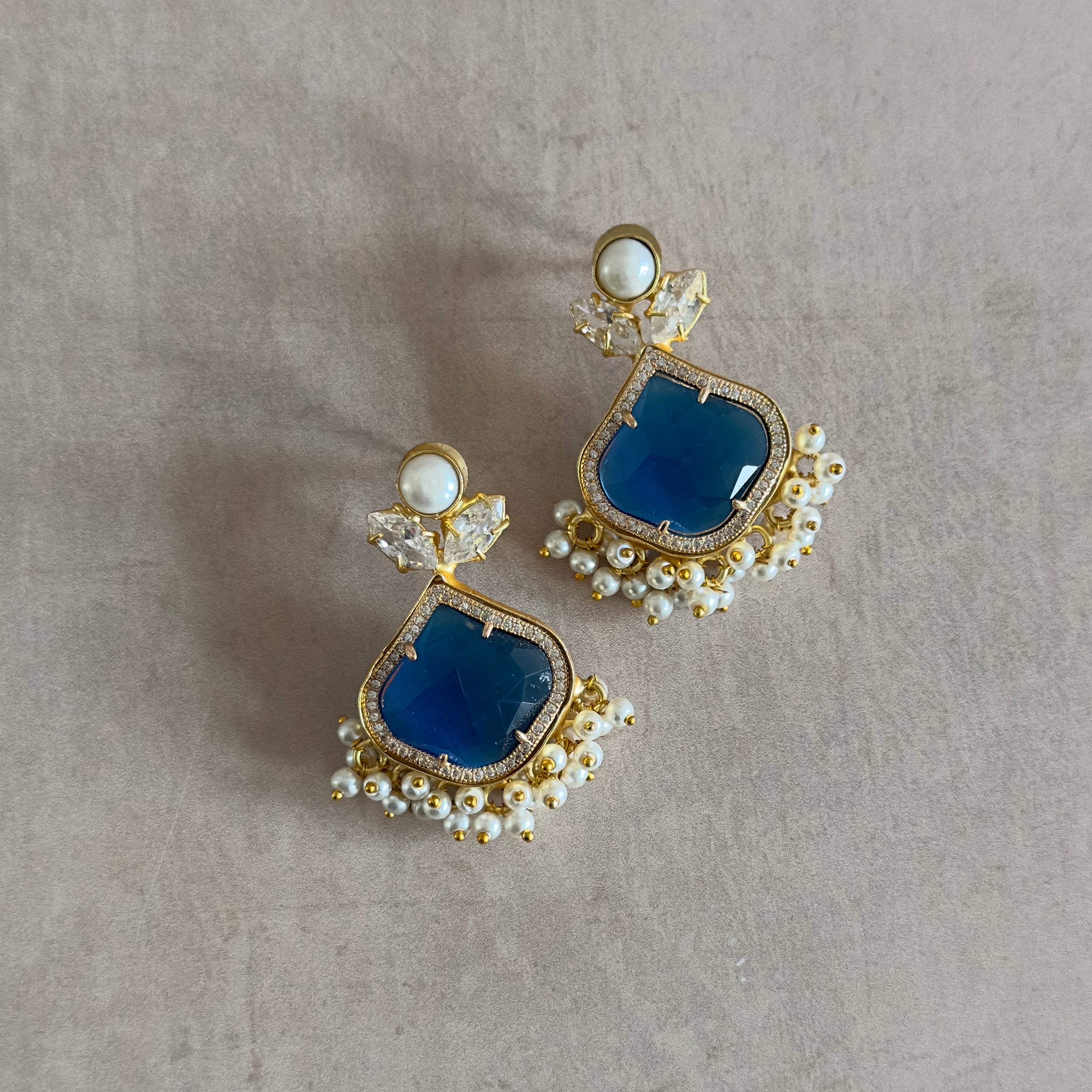 Introducing our Gaia Blue Earrings, a luscious new design featuring freshwater pearls and dazzling cz crystals. The beautiful vibrant blue adds a touch of natural elegance to these luxurious and exclusive earrings. Elevate your style today with these exquisit