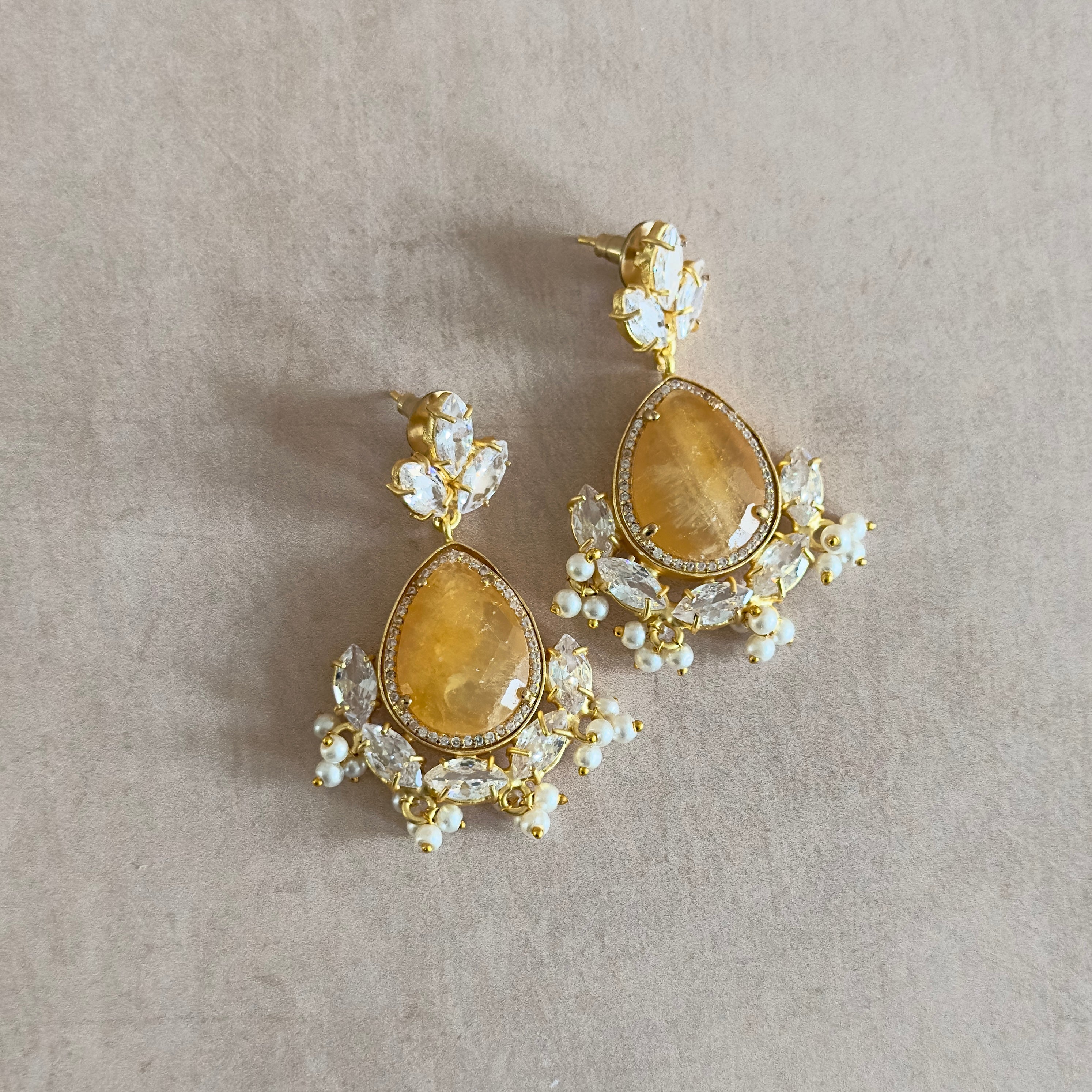 Feel the sparkling sensation with our Felice Crystal Drop Earrings featuring stunning lemon quartz and cz crystals. The perfect accessory to add a touch of elegance to any outfit. Shine bright and stand out in style!