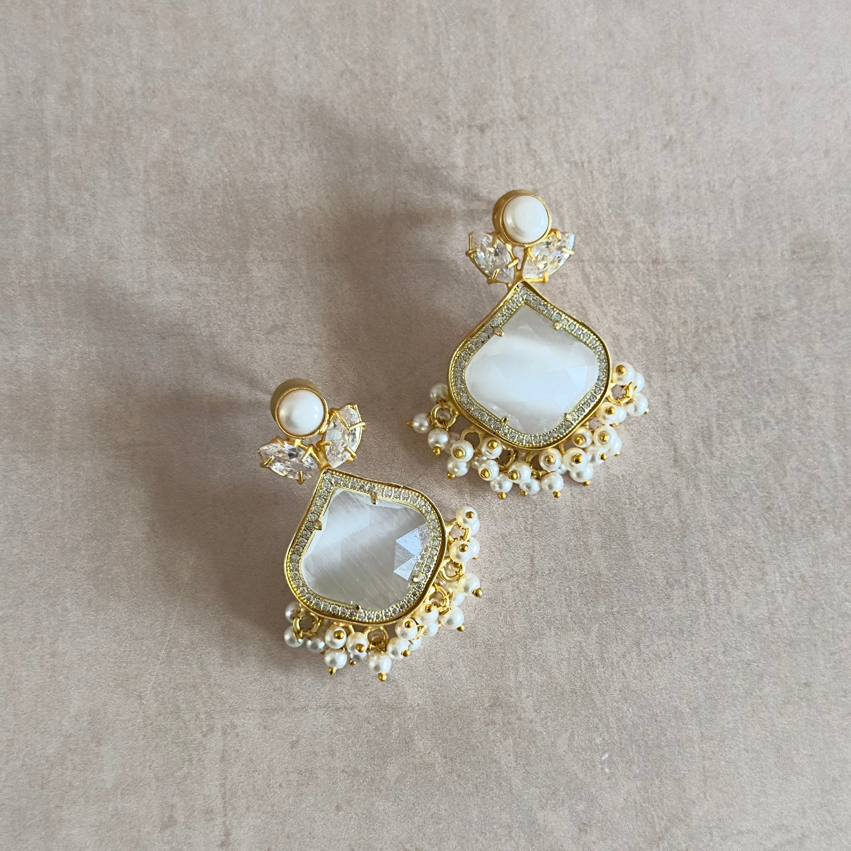 Introducing our Gaia Grey Pearl Earrings, a luscious new design featuring freshwater pearls and dazzling cz crystals. The beautiful grey stone adds a touch of elegance to these luxurious and exclusive earrings. Elevate your style today with these exquisite