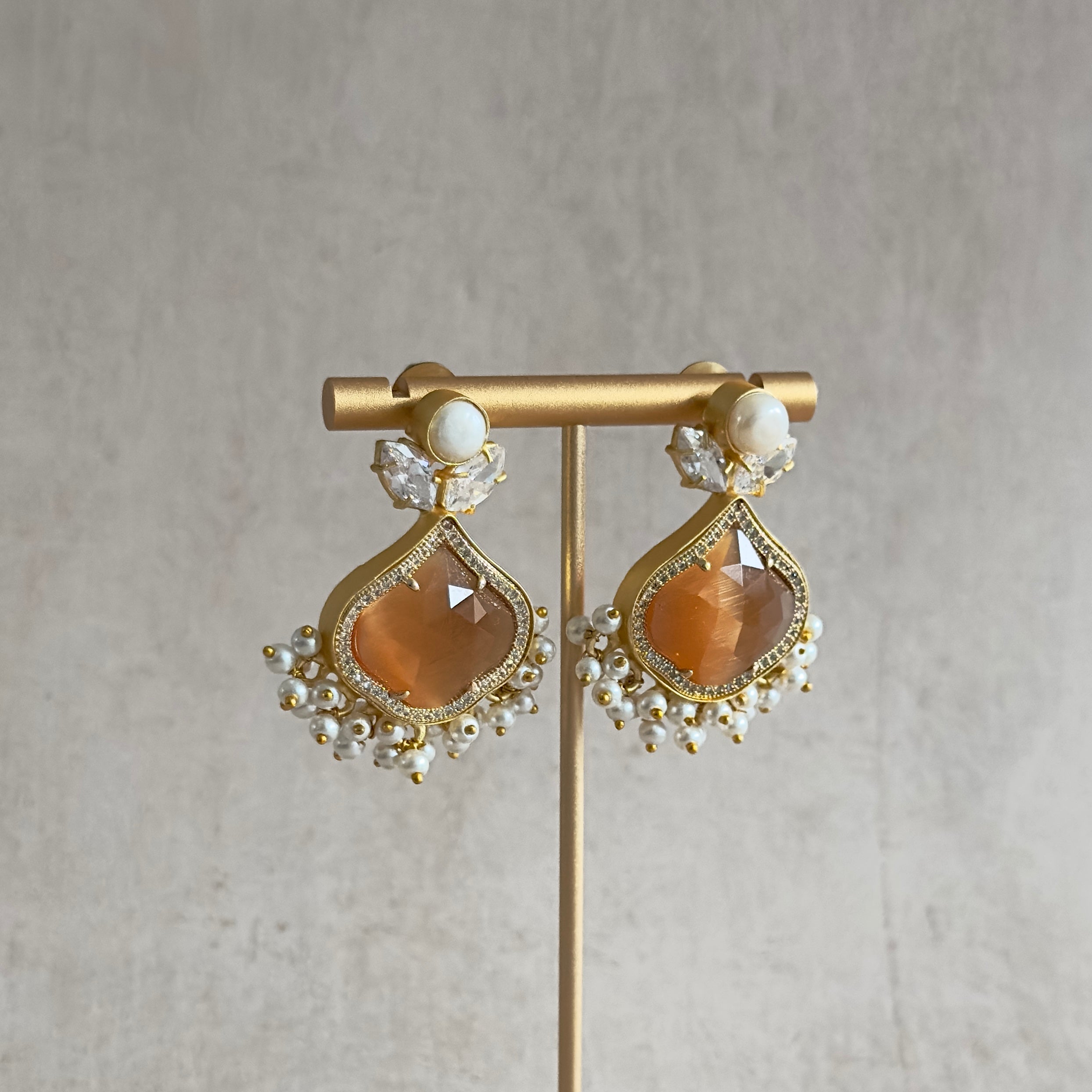 Introducing our Gaia Brown Pearl Earrings, a luscious new design featuring freshwater pearls and dazzling cz crystals. The beautiful brown honey stone adds a touch of natural elegance to these luxurious and exclusive earrings. Elevate your style today with these exquisite earrings.