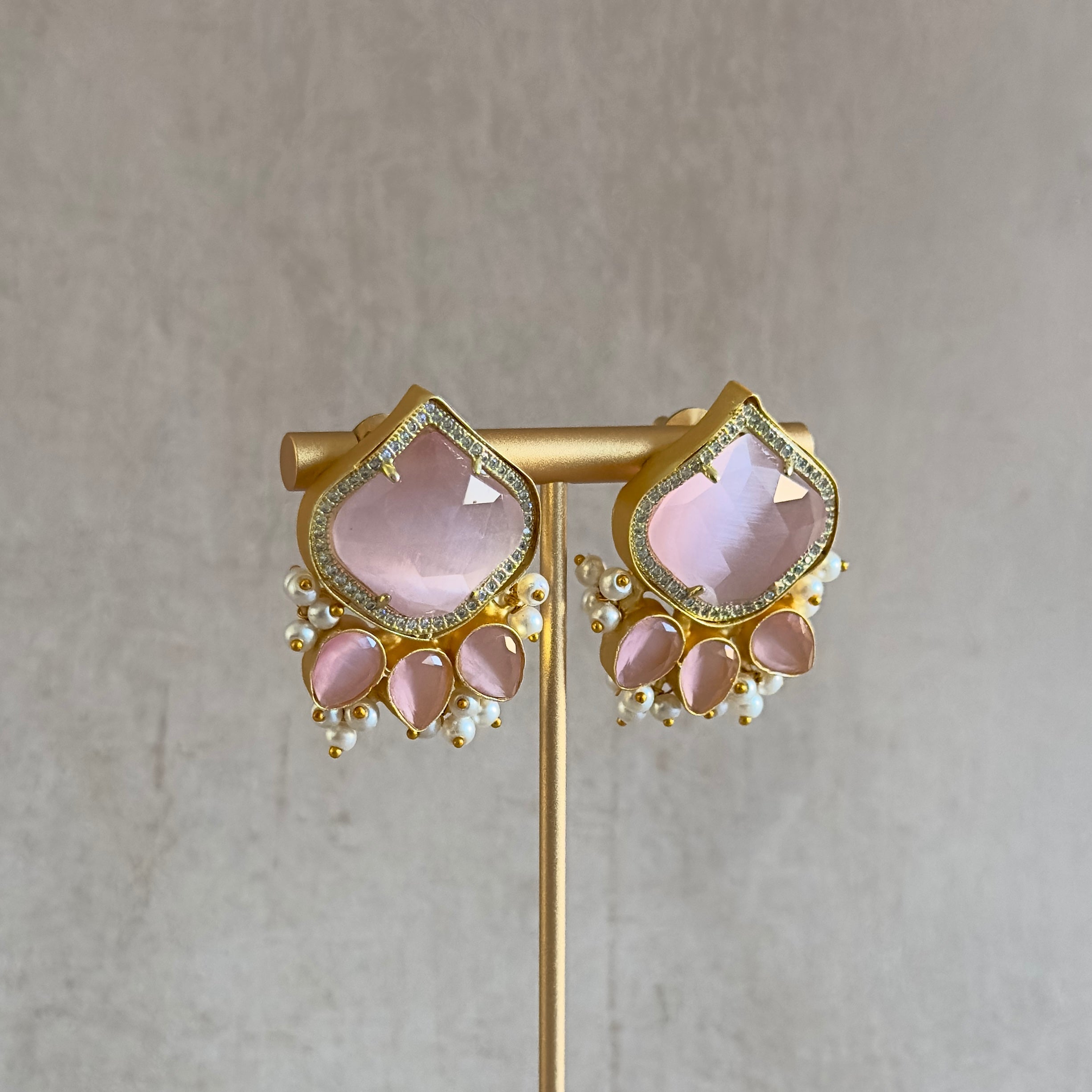 Unleash your inner sparkle with our Aria Pink Stud Earrings. Featuring stunning pink stones and sparkling CZ crystals, these earrings will add a touch of glamour to any outfit. Elevate your style and make a statement with these timeless studs.