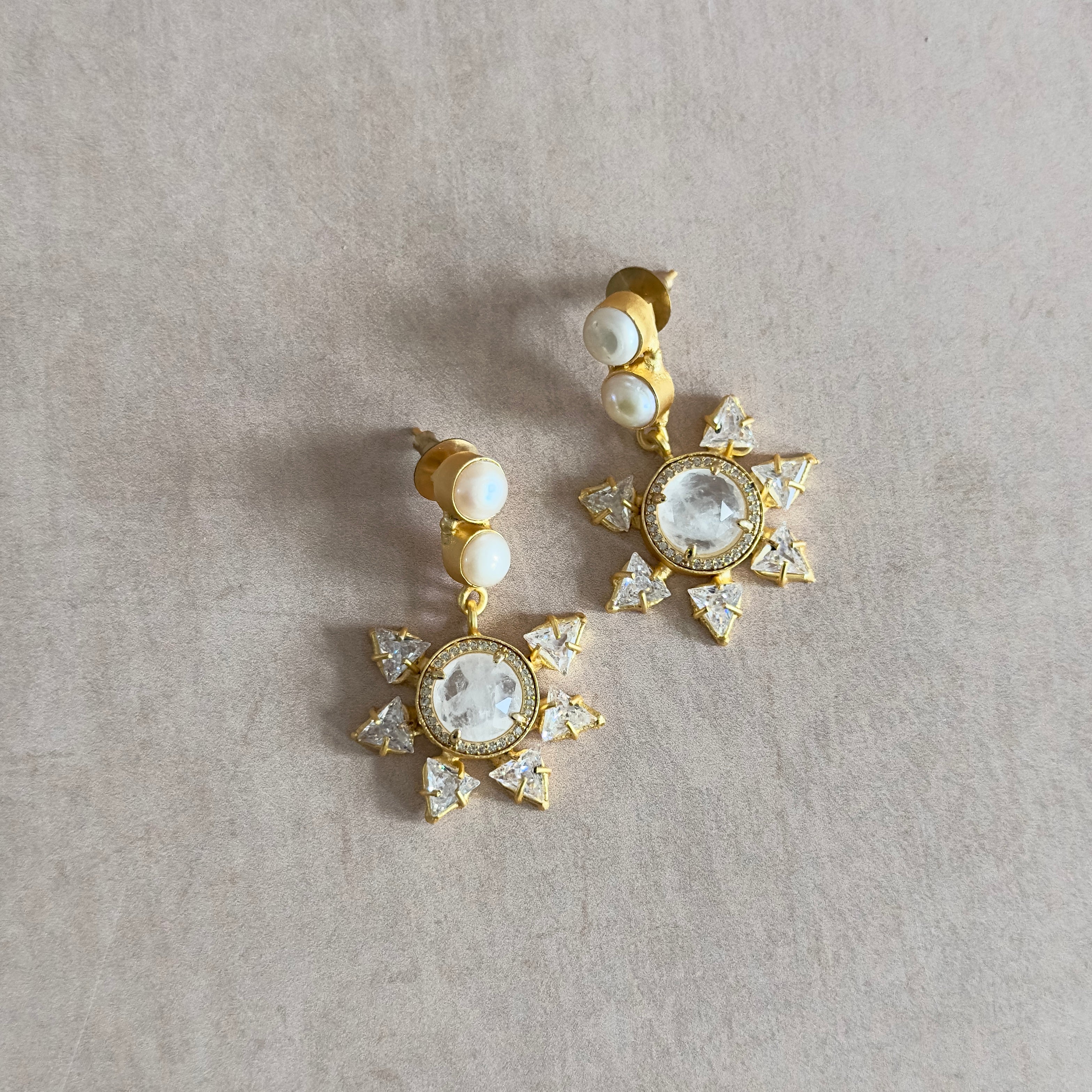 Introducing our Starry Pearl Drop Earrings, featuring white quartz and pearls. Add a touch of unique and fun elegance to any outfit with these stunning earrings. Perfect for any occasion, they are sure to make you stand out with their starry design.&nbsp;