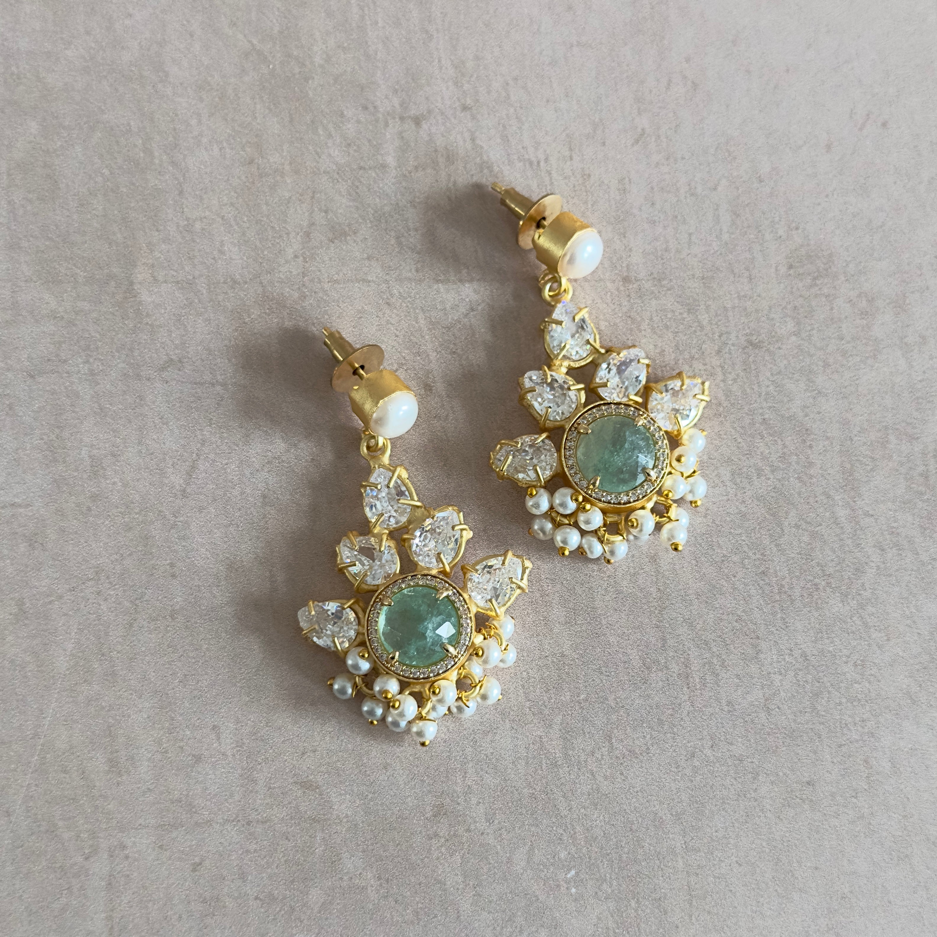 Add a touch of elegance to your outfit with our Claudia Pearl Crystal Drop Earrings! Featuring stunning aquamarine crystals and pearl accents, these earrings will make you stand out with their crystal details. Perfect for a night out or special occasion.