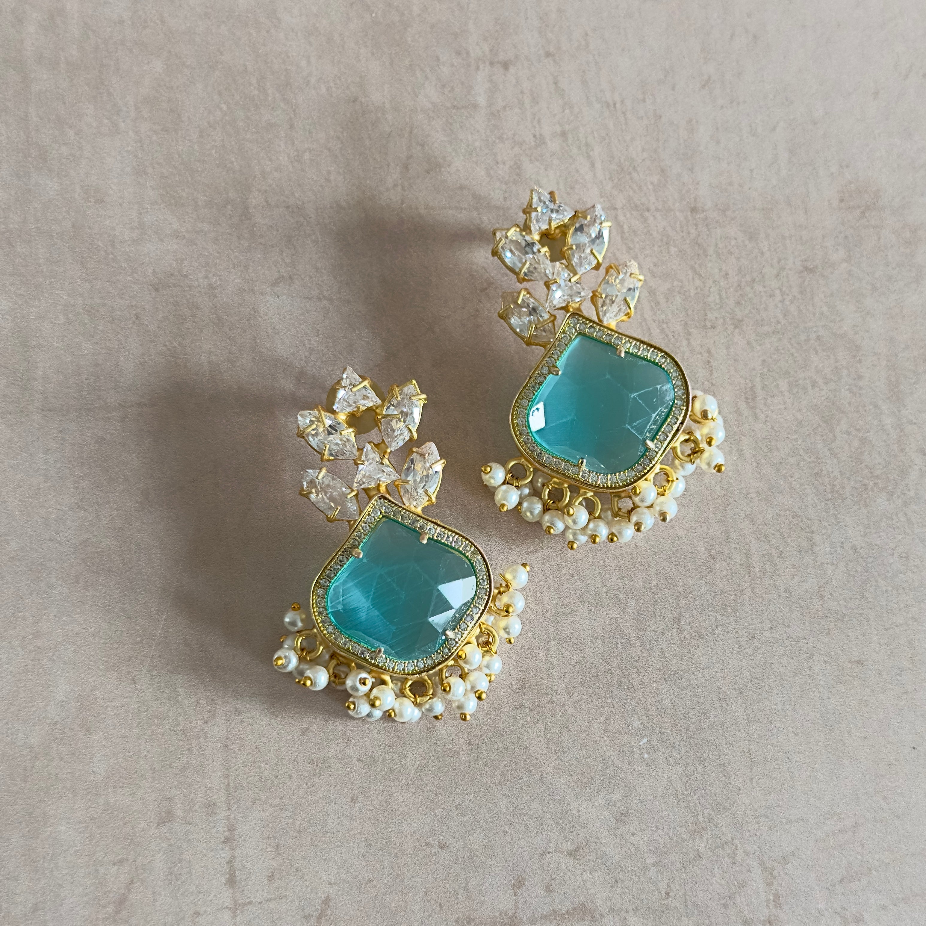 Indulge in the beauty and luxury of Isabella Crystal Earrings! These stunning statement earrings feature luscious aquamarine stones, inspired by the captivating waters of the Indian Ocean. With the added sparkle of cubic zirconia, these earrings will make a bold and glamorous addition to any outfit. Elevate your style and make a statement with Isabella.