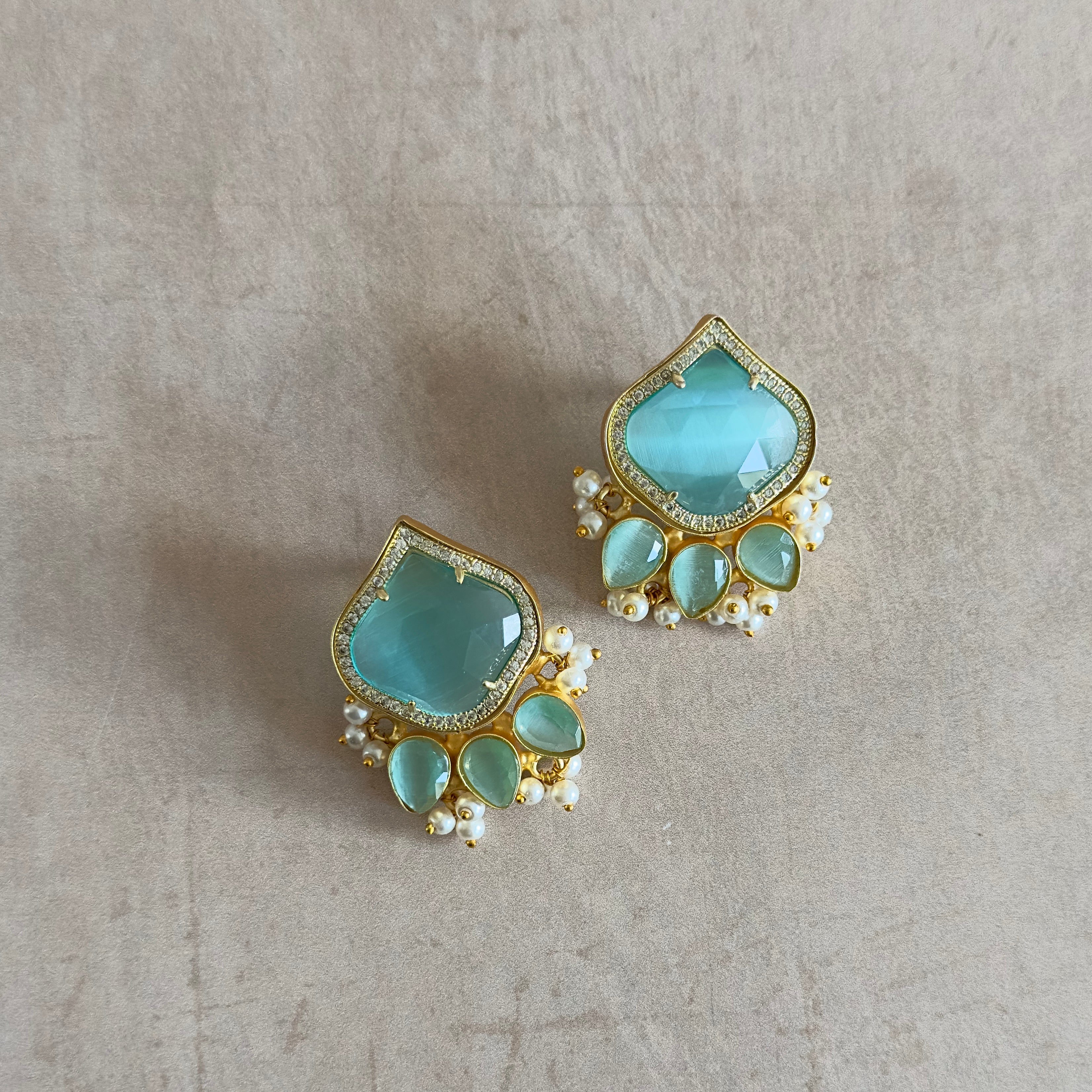 Indulge in effortless elegance with our Aria Mint Stud Earrings. The vibrant mint stones add a pop of color, while the delicate and simple design exudes sophistication. Elevate any outfit with these must-have earrings.