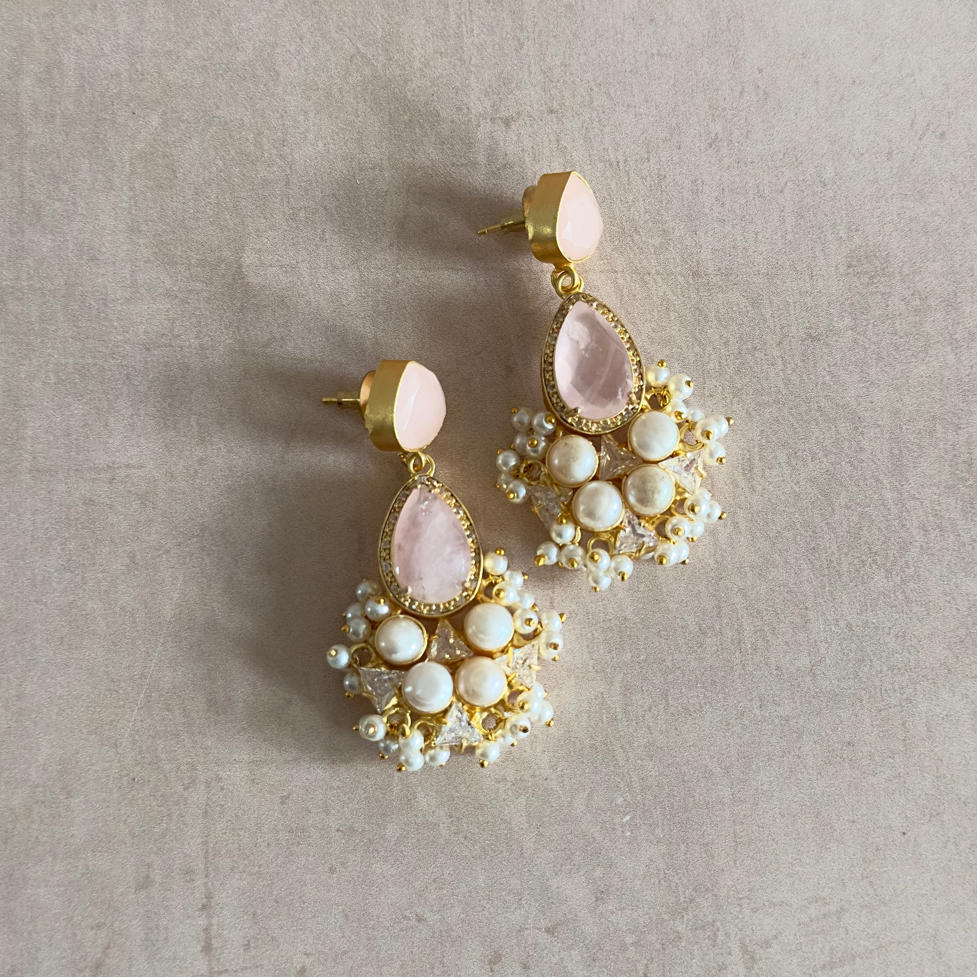 Add a touch of elegance with our Romee Pink Pearl Drop Earrings. Made with beautiful rose quartz, freshwater pearls, and delicate crystal details, these earrings exude grace and sophistication. Elevate your style and make a statement with our stunning and timeless pieces.