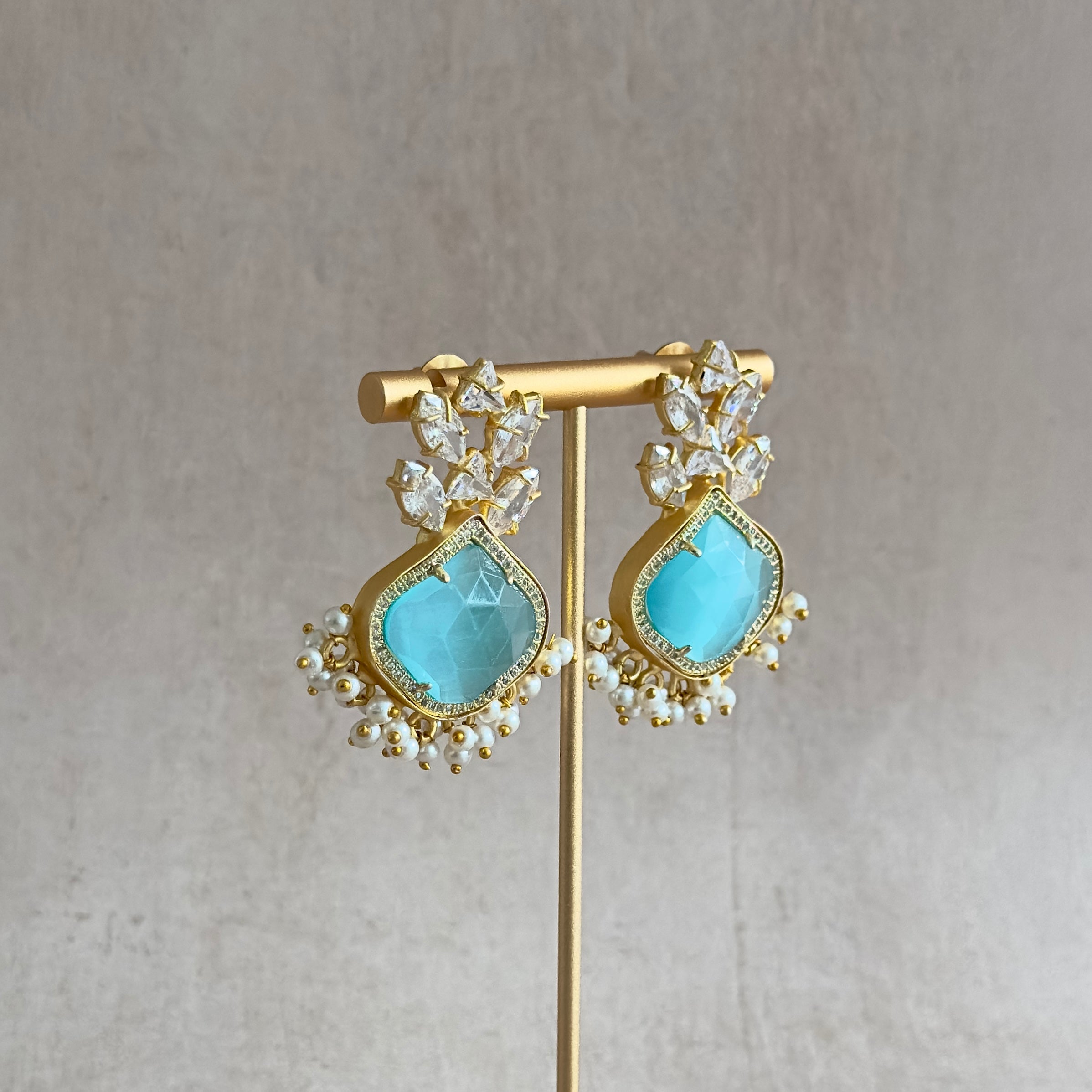 Indulge in the beauty and luxury of Isabella Crystal Earrings! These stunning statement earrings feature luscious aquamarine stones, inspired by the captivating waters of the Indian Ocean. With the added sparkle of cubic zirconia, these earrings will make a bold and glamorous addition to any outfit. Elevate your style and make a statement with Isabella.
