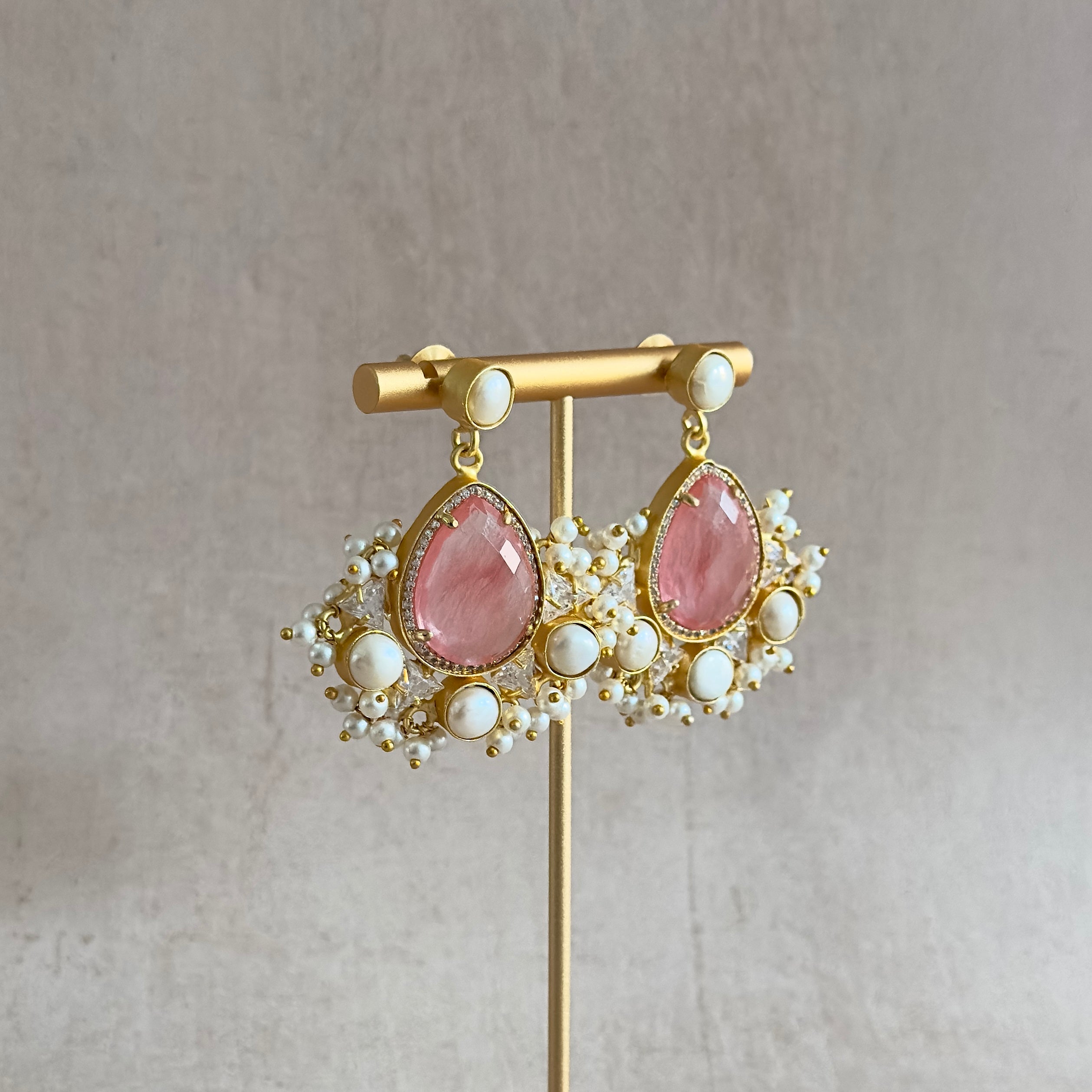 Elevate your style with our Poppy Crimson Pearl Drop Earrings! Hand cut crimson quartz crystals and freshwater pearls adorn these stunning earrings, adding a touch of elegance to any outfit. With intricate crystal details, these earrings are sure to catch the eye and make a statement.