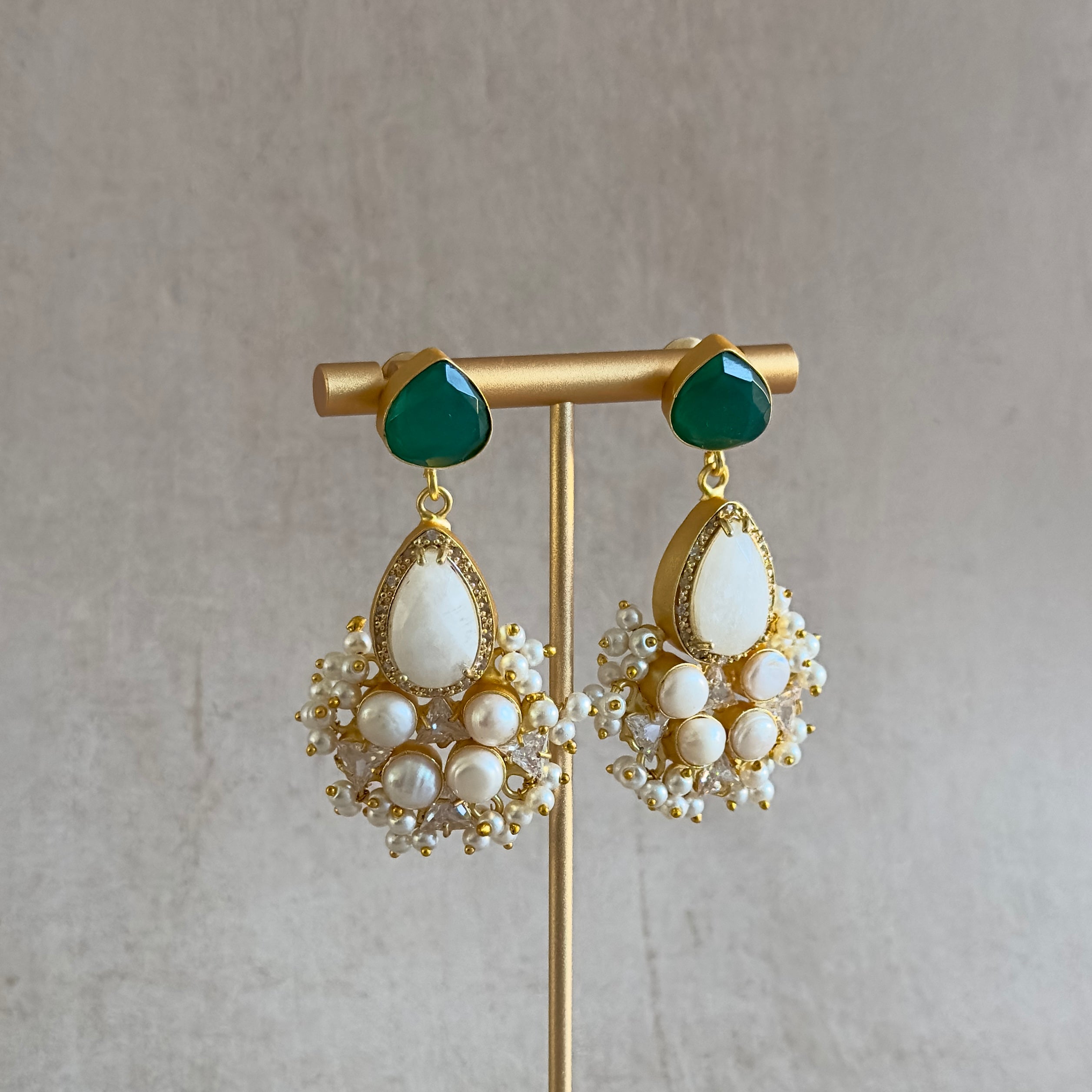 Elevate your look with the Romee Green Drop Earrings! The stunning hues of green and pearl complemented by white quartz crystals exude a sense of elegance and luxury. Add a touch of sophistication to any outfit and make a statement wherever you go. Get ready to turn heads and feel confident in these beautiful earrings!