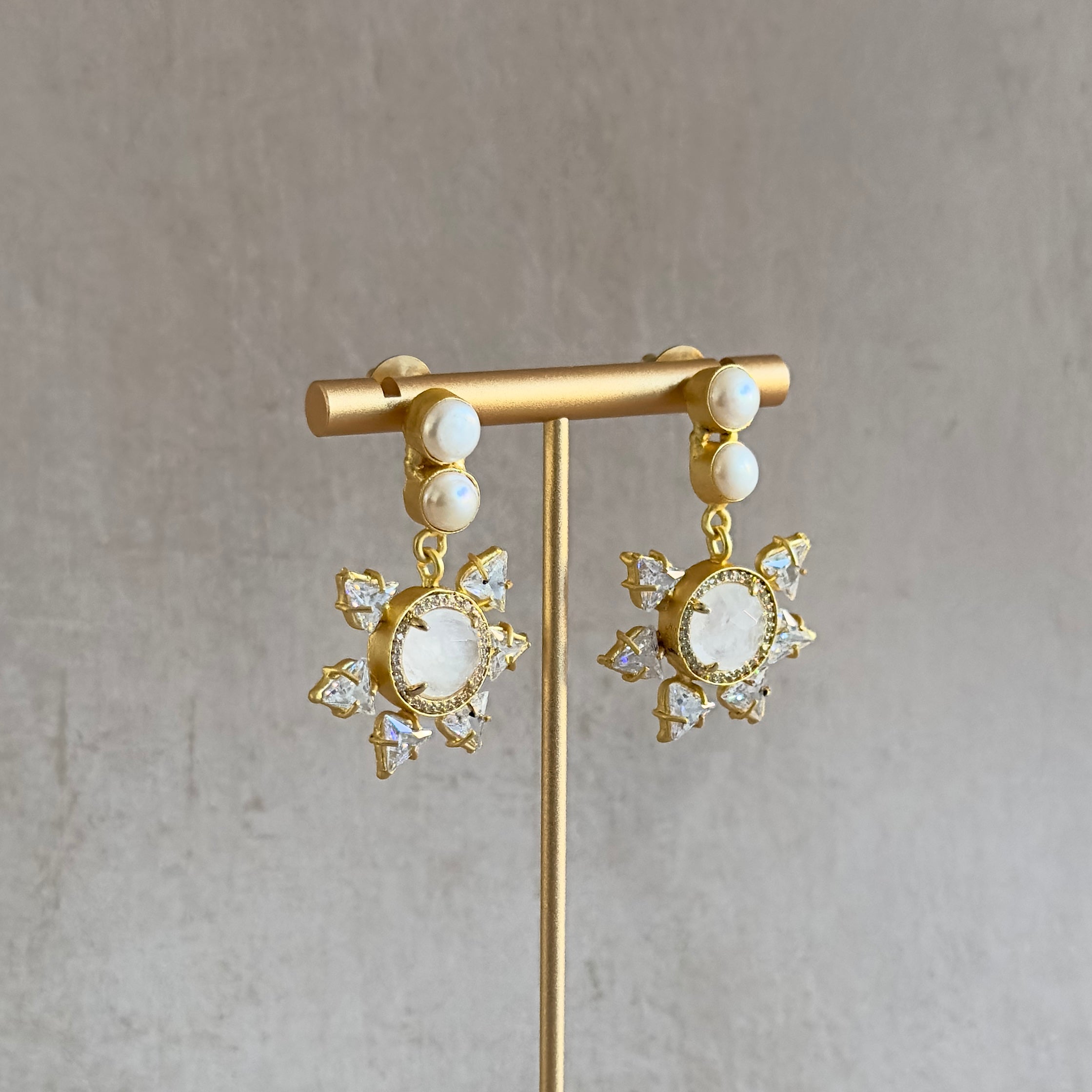 Introducing our Starry Pearl Drop Earrings, featuring white quartz and pearls. Add a touch of unique and fun elegance to any outfit with these stunning earrings. Perfect for any occasion, they are sure to make you stand out with their starry design.&nbsp;