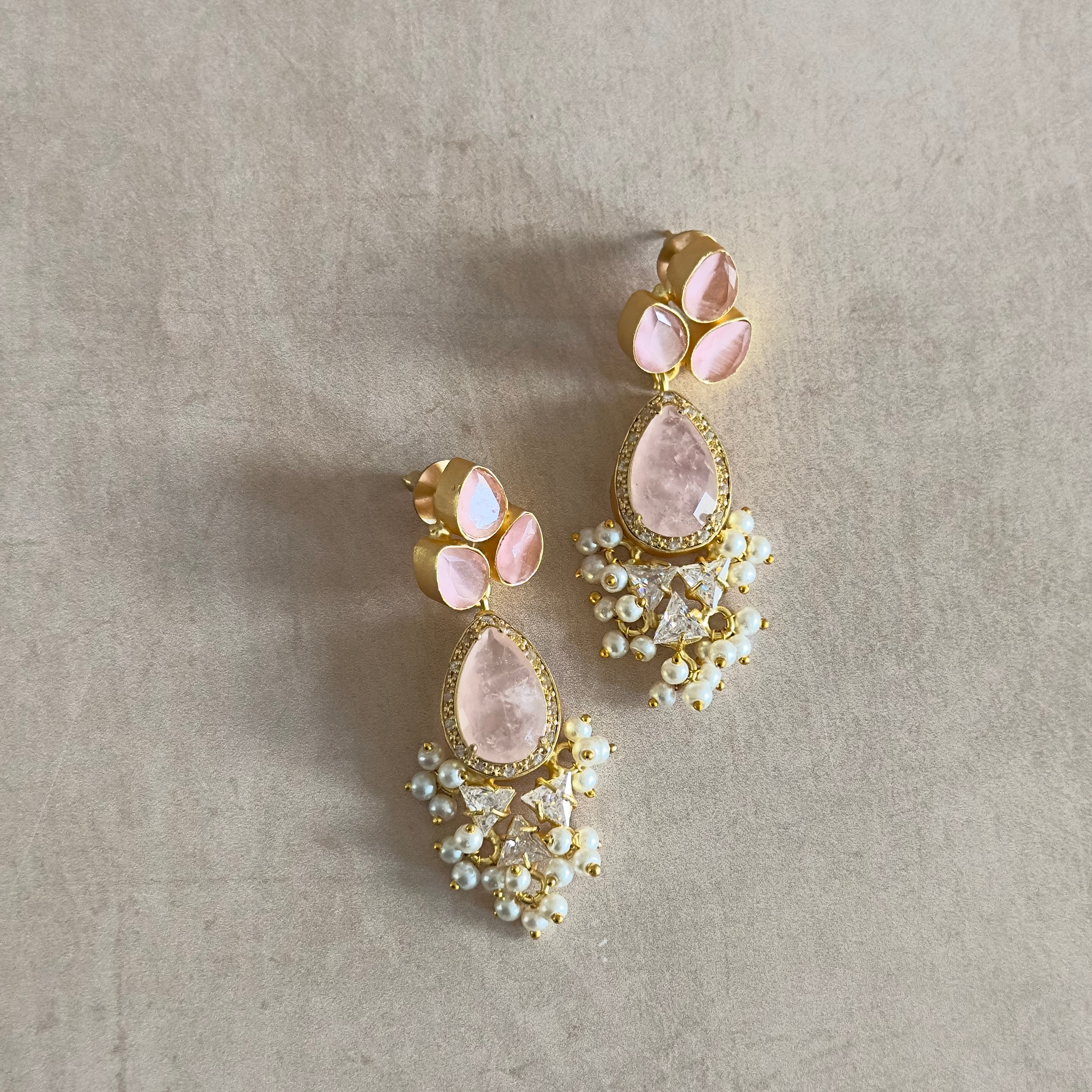 Elevate your style with our Romee Pink Drop Earrings! These stunning earrings feature a combination of rose quartz and sparkling cz crystals, adding a touch of luxury to any outfit. Make a bold statement and turn heads with these must-have earrings. Perfect for any occasion and sure to impress!