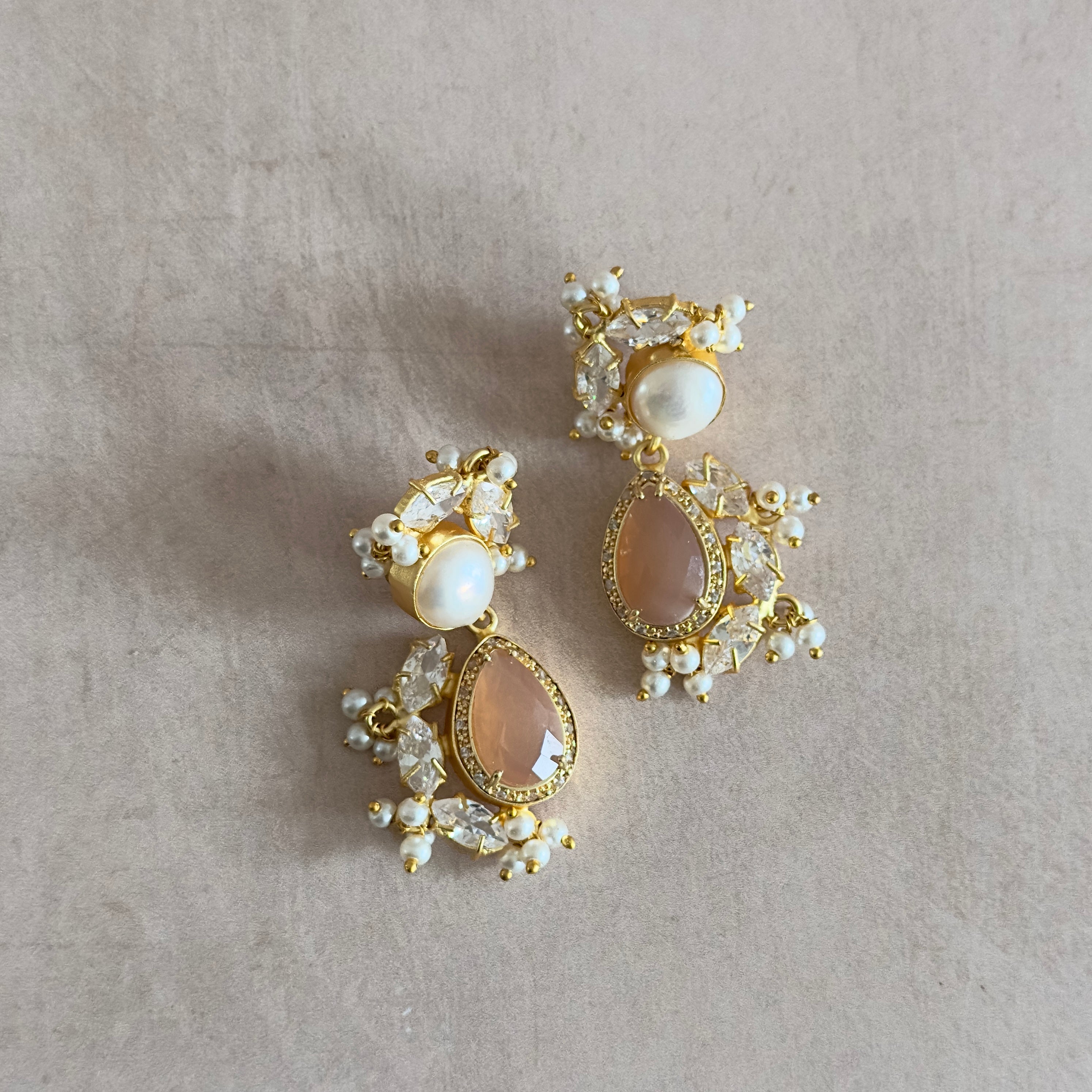 Transform your look with our Peachy Pearl Drop Earrings! Each piece is delicately crafted with peach moonstone and freshwater pearls to add a touch of elegance and natural beauty to any outfit. Elevate your style and embrace the benefits of these stunning earrings.