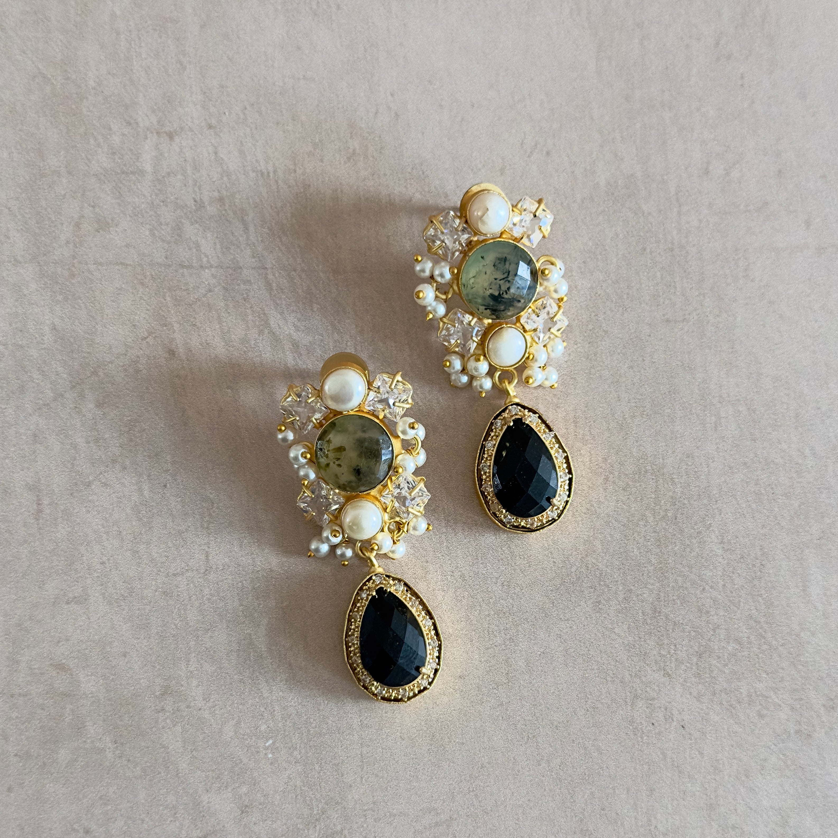 Add a touch of elegance to any outfit with our Lela Black Pearl Earrings! These stunning multi gemstone earrings feature sparkling CZ crystals, bringing a touch of glamour and sophistication to your look. Perfect for any occasion, these earrings are sure to make a statement and elevate your style.