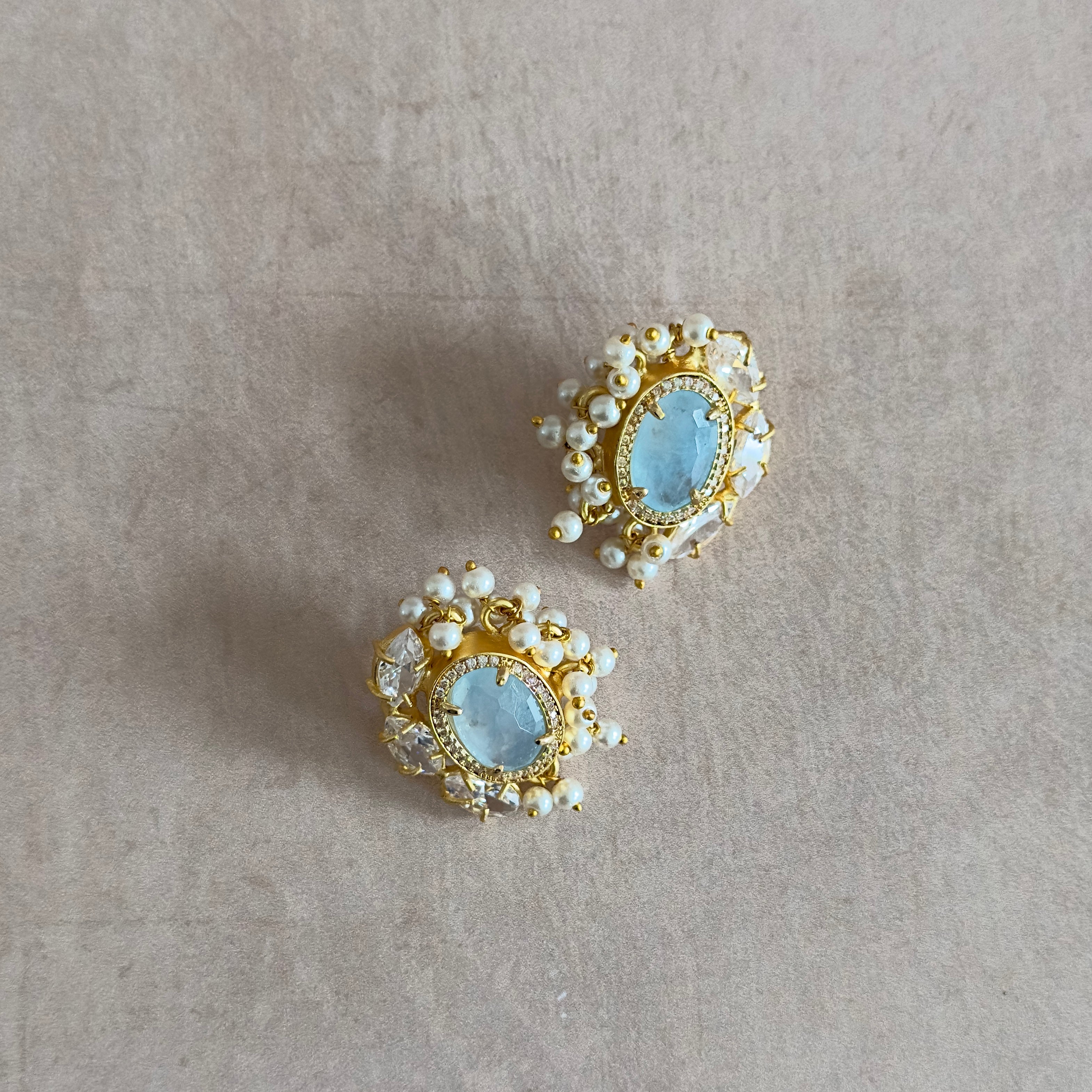 Sparkle and shine with our Blue Crystal Stud Earrings! The stunning blue crystal center is surrounded by sparkling cubic zirconia for an eye-catching look. Elevate any outfit with these elegant earrings that are perfect for any occasion.