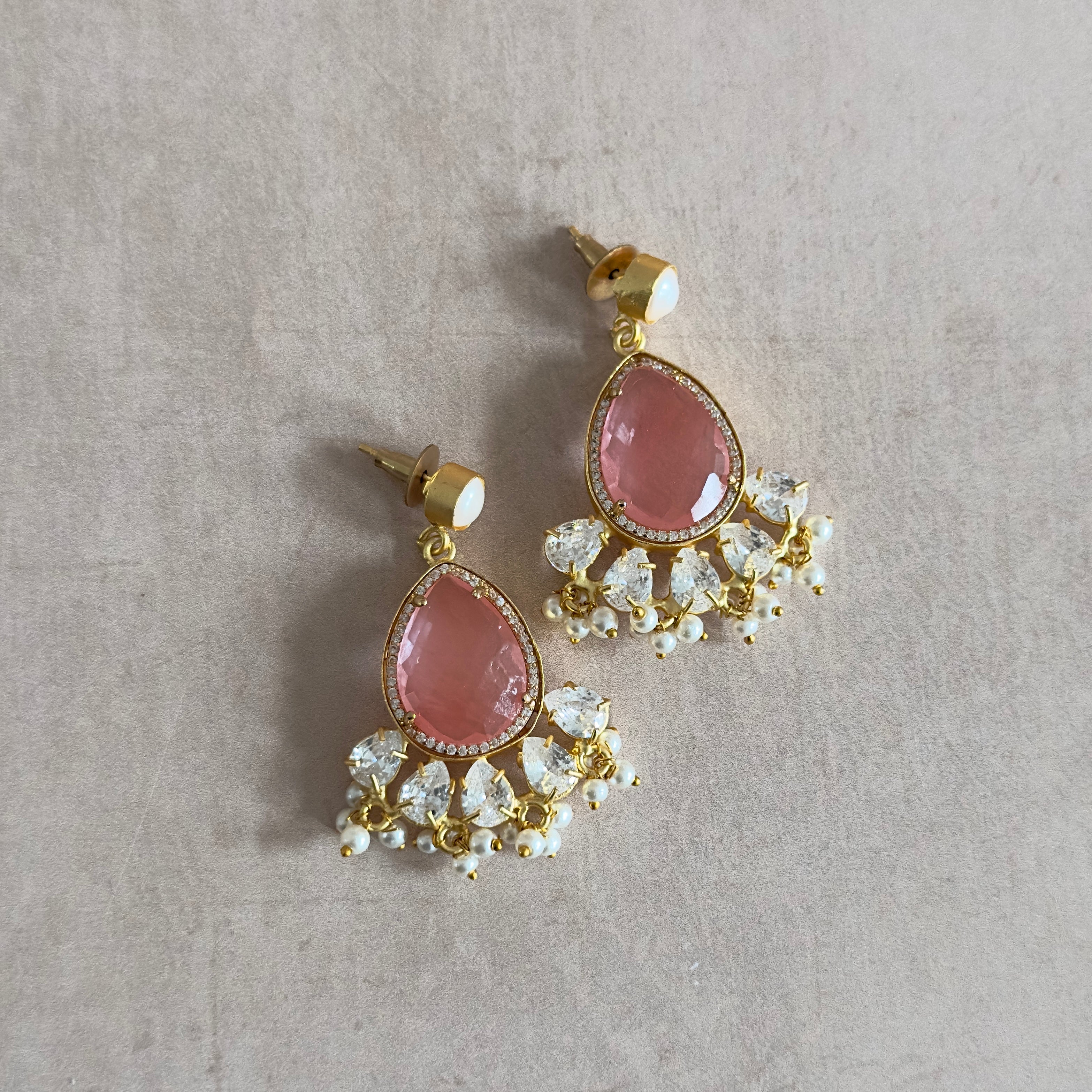 Enhance your style with our Molly Crystal Drop Earrings! Featuring a stunning crimson crystal with delicate pearl accents and sparkling cubic zirconia, these earrings will add a touch of elegance and glamour to any outfit. Elevate your look and shine bright with these eye-catching earrings.